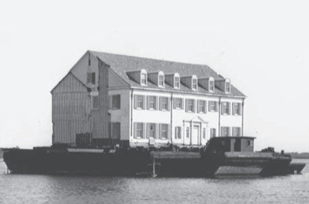 The Main Clubhouse, built by Edward Scudder, being transported by barge to the Rumson Country Club. Photo courtesy of The Rumson Country Club.