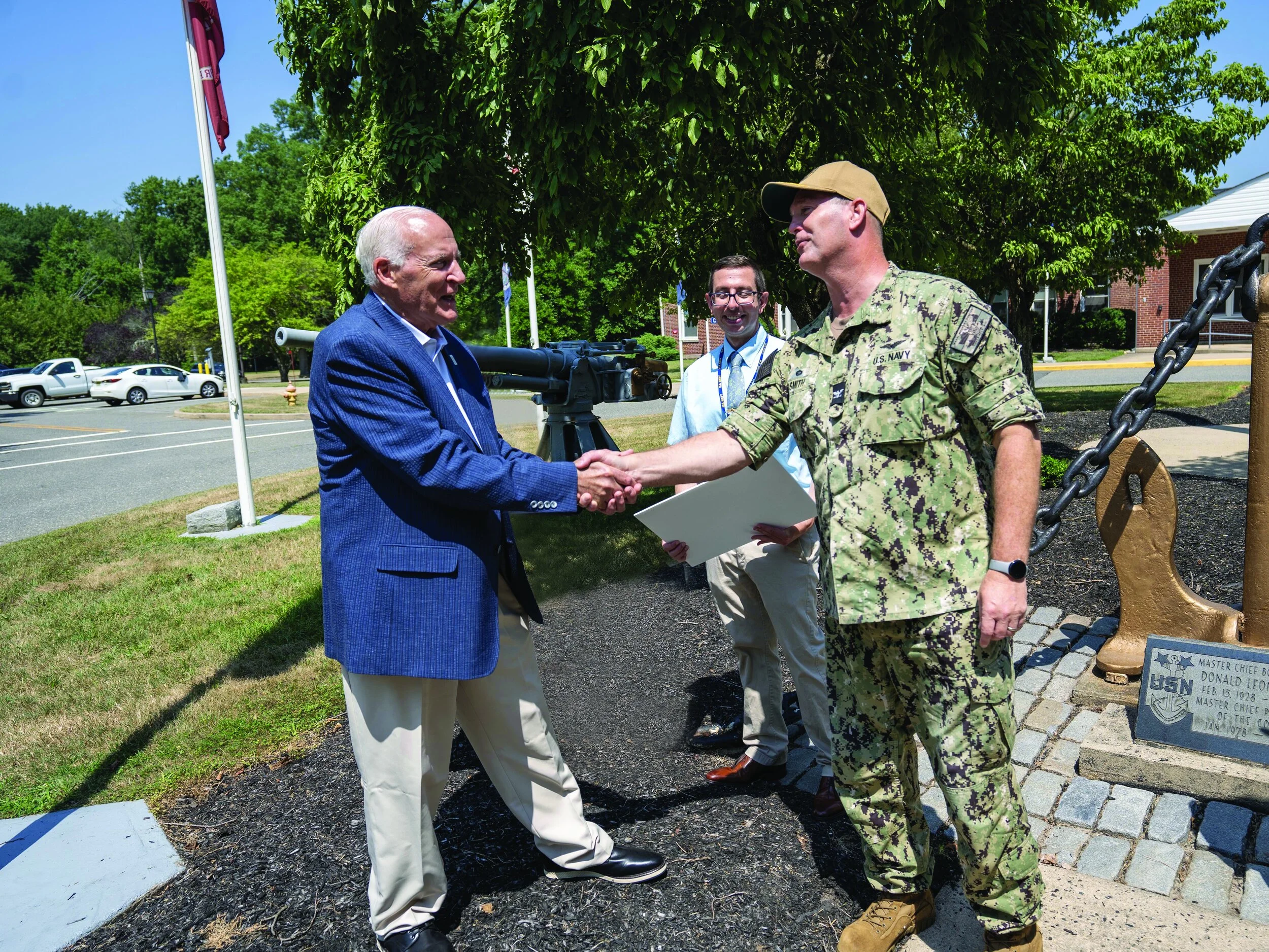 L-R Front: MCF Executive Director William D. Kastning shakes hands with NWS Earle Commanding Officer Capt. Kent D. Smith. Back: NWS Earle Community Plans and Liaison Officer Nicholas Ginther
