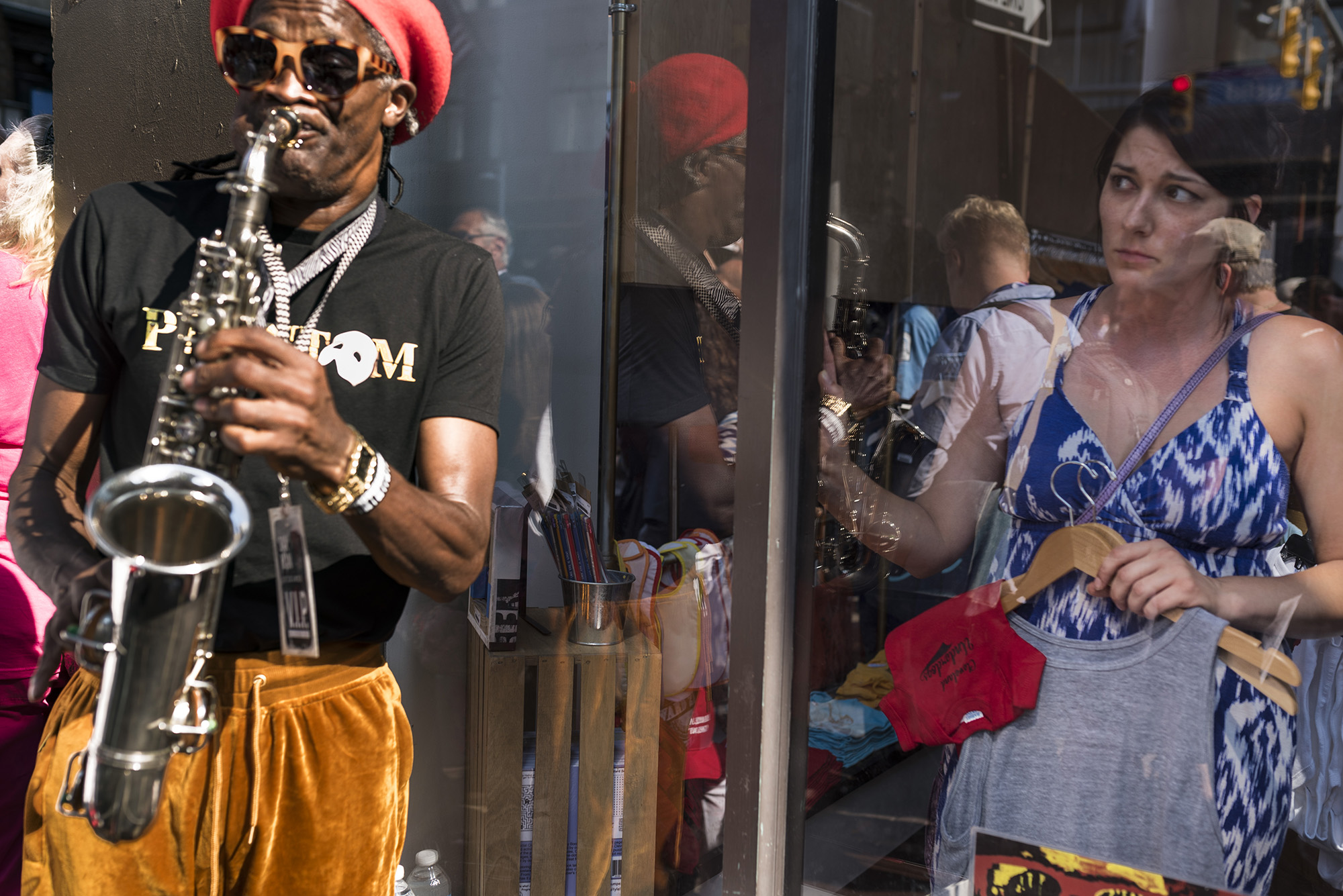 A woman inside the store look as protester marched pass the store in protest of Trump presidential campaign, on July 19, 2016.