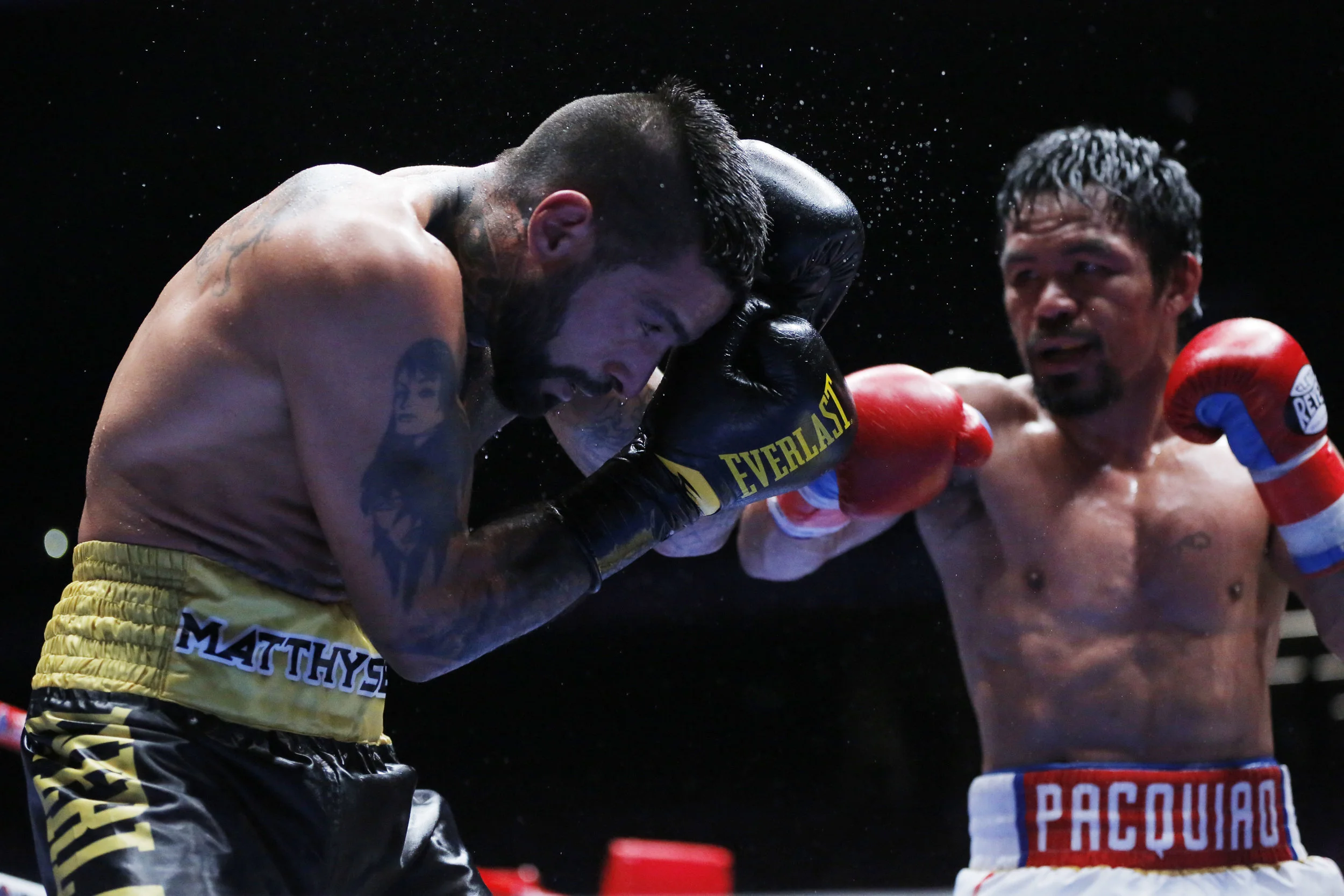Manny Pacquiao of the Philippines, left, celebrates after defeating Lucas Matthysse of Argentina during their WBA World welterweight title bout in Kuala Lumpur, Malaysia, Sunday, July 15, 2018. (AP Photo/Yam G-Jun)