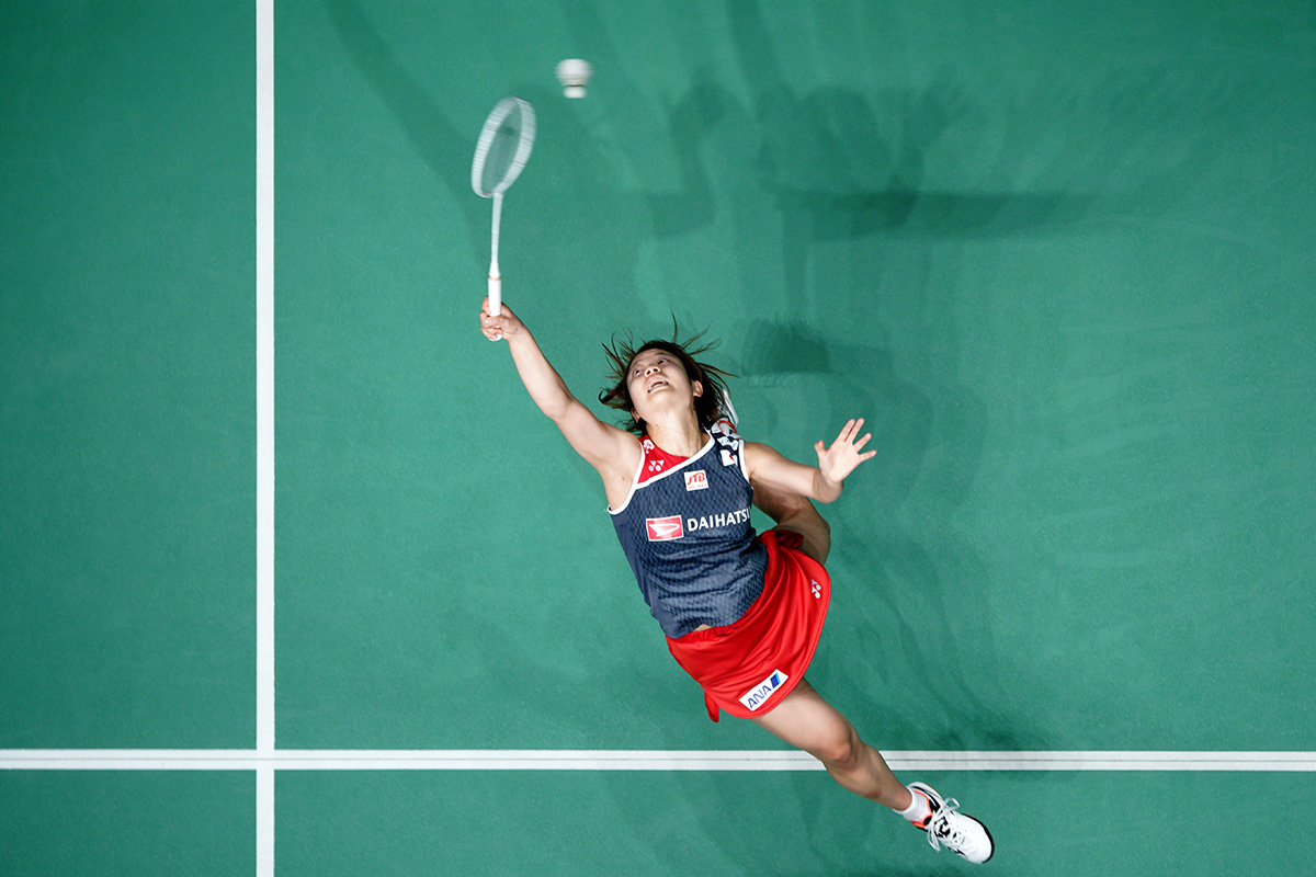 Chen Long of China falls after missing a shot from Viktor Axelsen of Denmark during the men's singles semifinal of the Malaysia Masters badminton tournament in Kuala Lumpur, Malaysia, Saturday, Jan. 19, 2019. (AP Photo/Yam G-Jun)