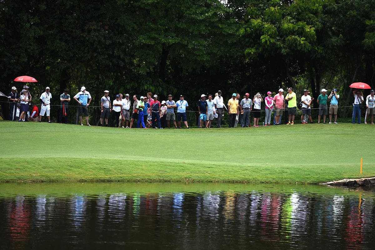 Spectators watch the final round of the CIMB Classic golf tournament at Tournament Players Club (TPC) in Kuala Lumpur, Malaysia, Sunday, Oct. 14, 2018. (AP Photo/Yam G-Jun)