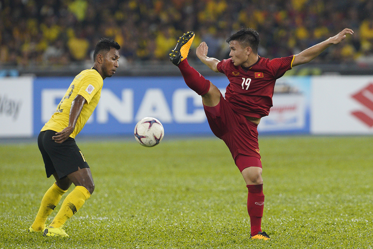 Vietnam national soccer team supporters celebrate after their team scored a goal during the AFF Suzuki Cup final soccer match between Malaysia and Vietnam in Kuala Lumpur, Malaysia, Tuesday, Dec. 11, 2018. (AP Photo/Yam G-Jun)