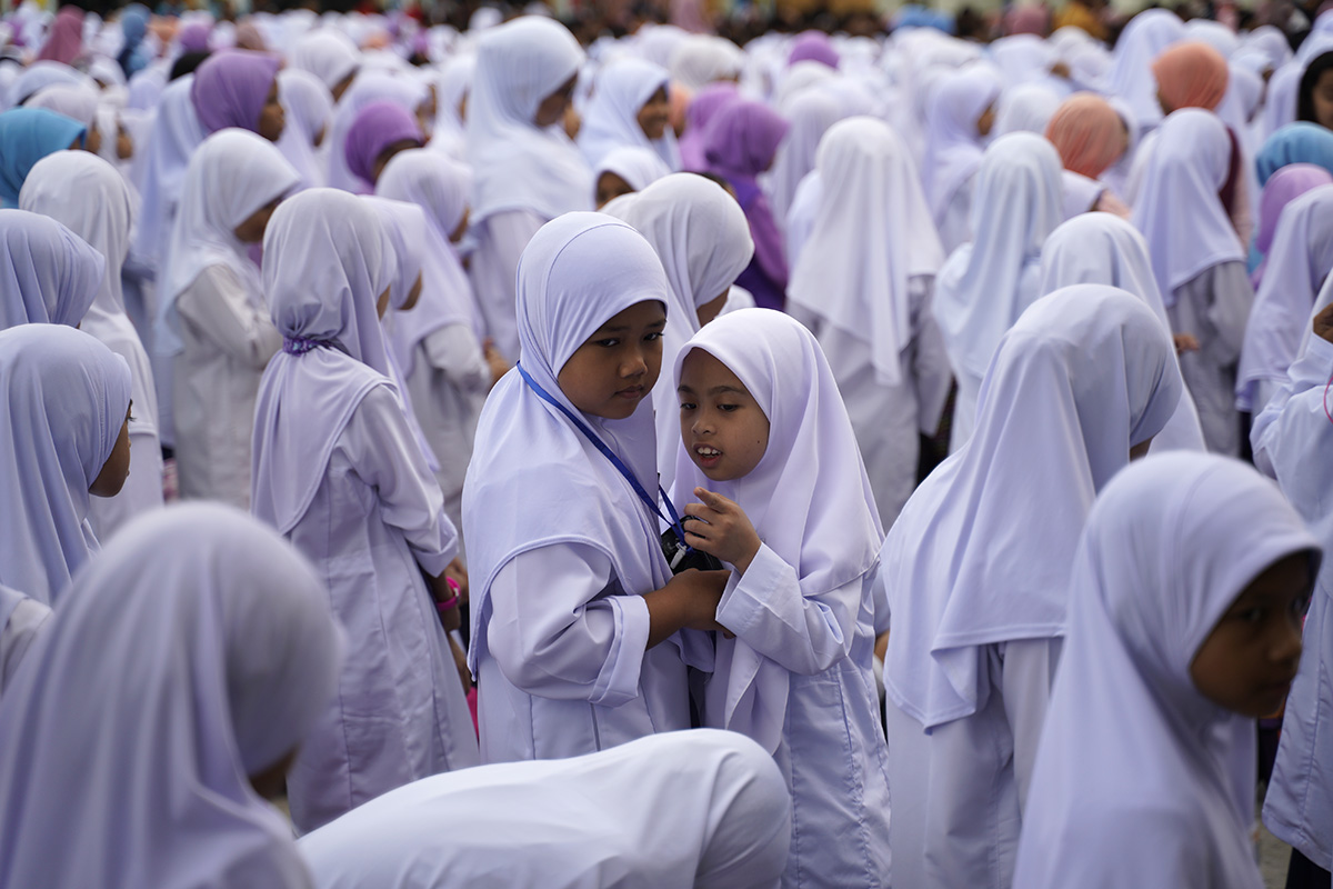Primary school students talk during the first day of the new school session in Putrajaya, Malaysia, Wednesday, Jan. 2, 2019. Malaysia began the first day of new school session on Jan. 2. (AP Photo/Yam G-Jun)