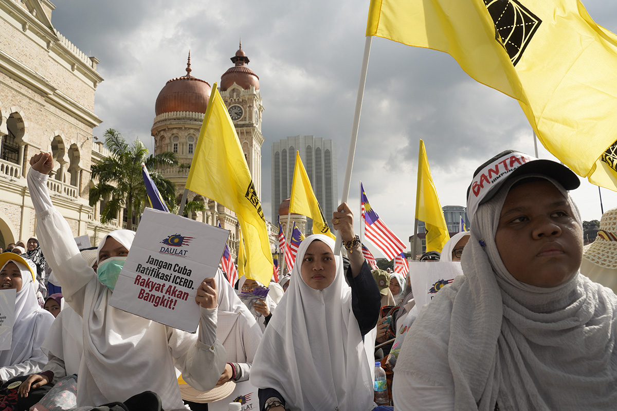 Thousands of protesters take a part in a rally to celebrate the government's move to withdraw plans to ratify a U.N. anti-discrimination convention at Independent Square in Kuala Lumpur, Malaysia, Saturday, Dec. 8, 2018. (AP Photo/Yam G-Jun)