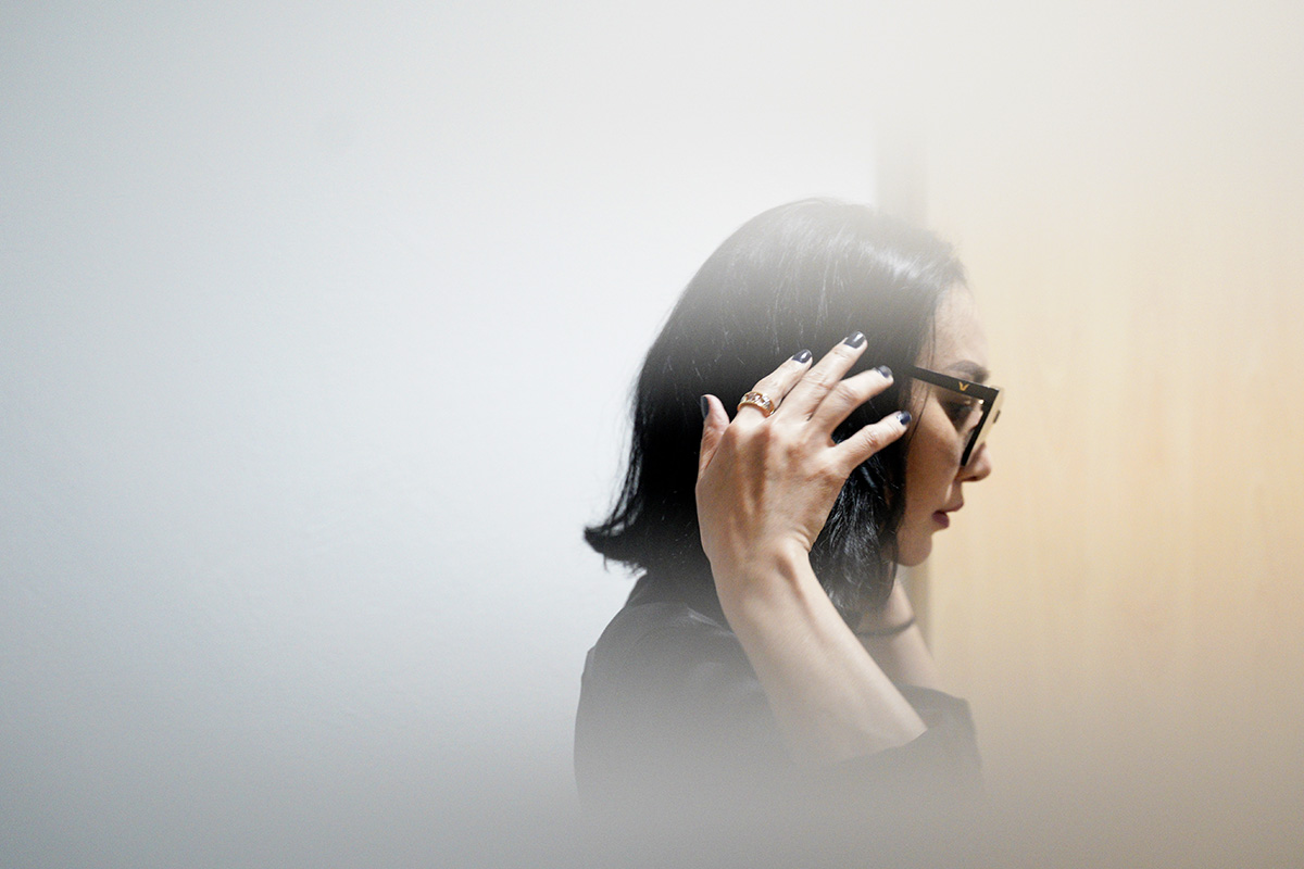 In this photo taken through frosted glass, Burmaa Oyubchineg, cousin of the murdered Mongolian model Altantuya Shaariibuu, arrives at Shah Alam High Court in Shah Alam, Malaysia, Wednesday, Jan. 23, 2019. (AP Photo/Yam G-Jun)