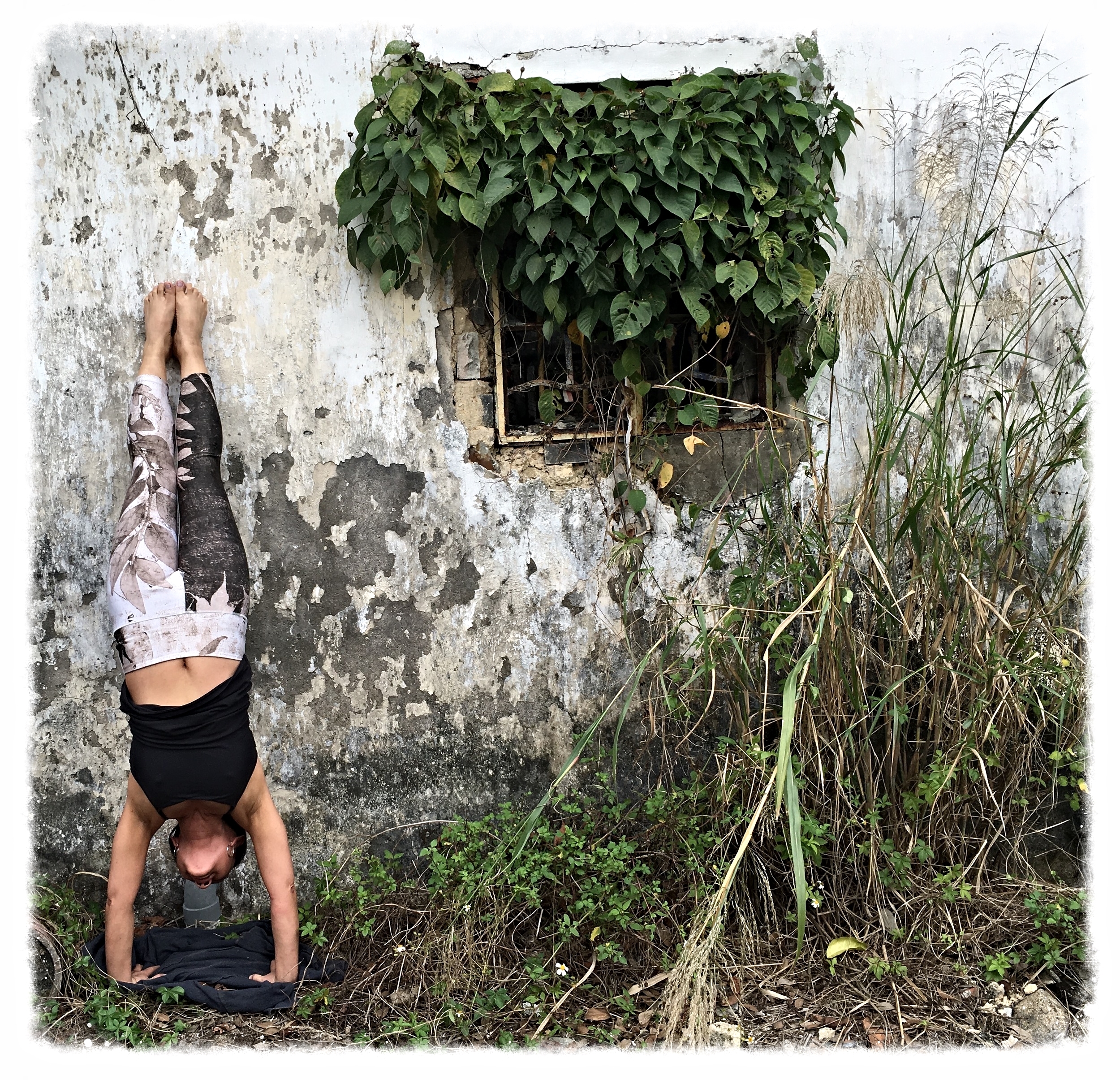 Hand Stand by an abandoned village house, Hong Kong