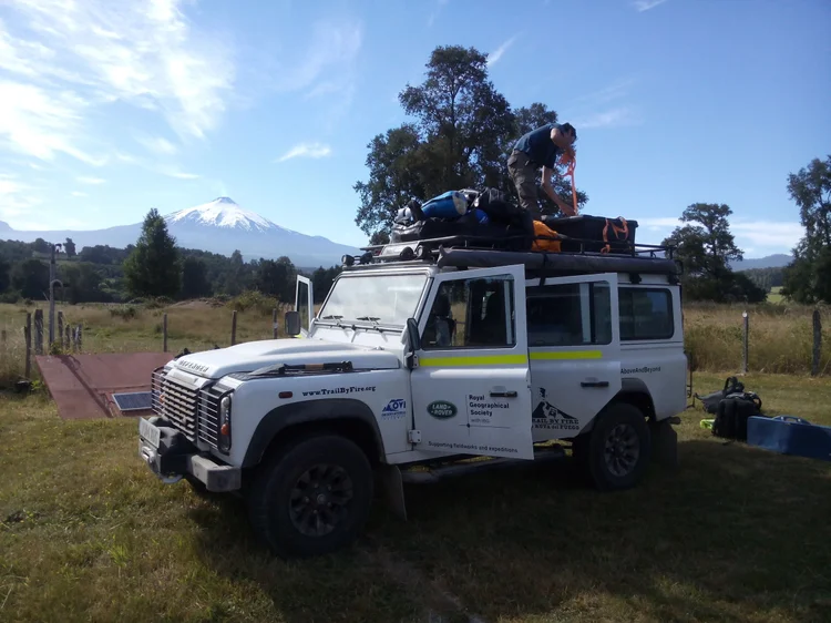 Loading the white Trail by Fire Defender: two small roof lamps, packed awning, equipment and side livery.
