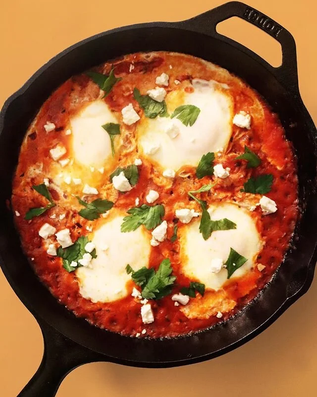 Unfreeze your Sunday Sauce and make Eggs in Purgatory today, tomorrow, any day.
Since our sauce already has garlic + onions it we set it as our base, add a few more diced tomatoes, crack a few eggs, top with parsley + feta, and VOILA! It&rsquo;s not 