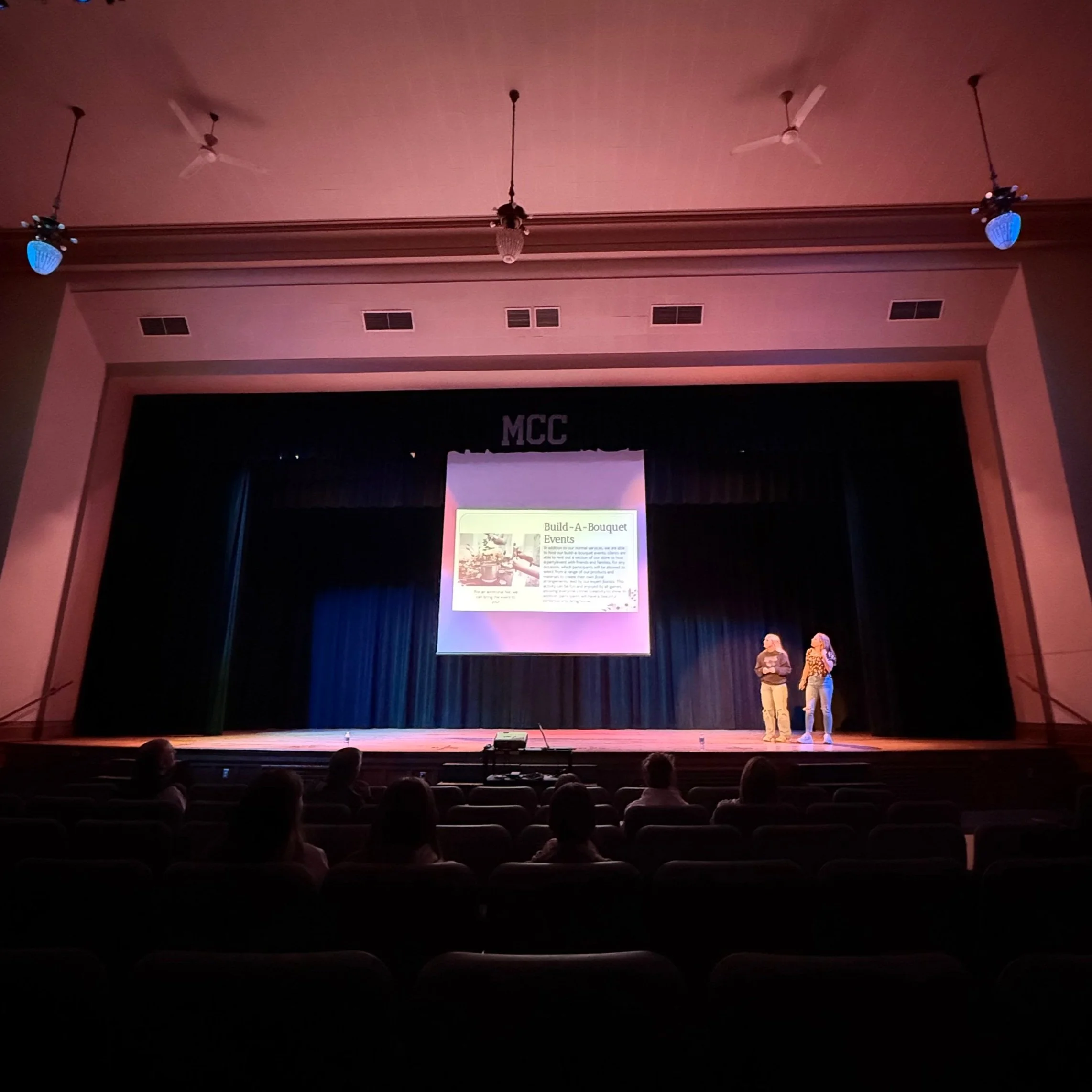 Student presenting a business pitch during a Shark Tank classroom simulation activity for middle school economics