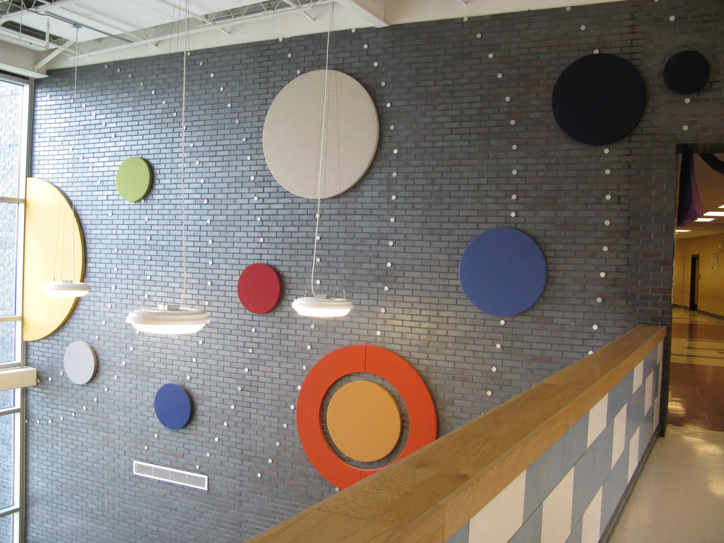  On the right side of the two story atrium space is a model of the solar system in acoustical panels and metal disks. 