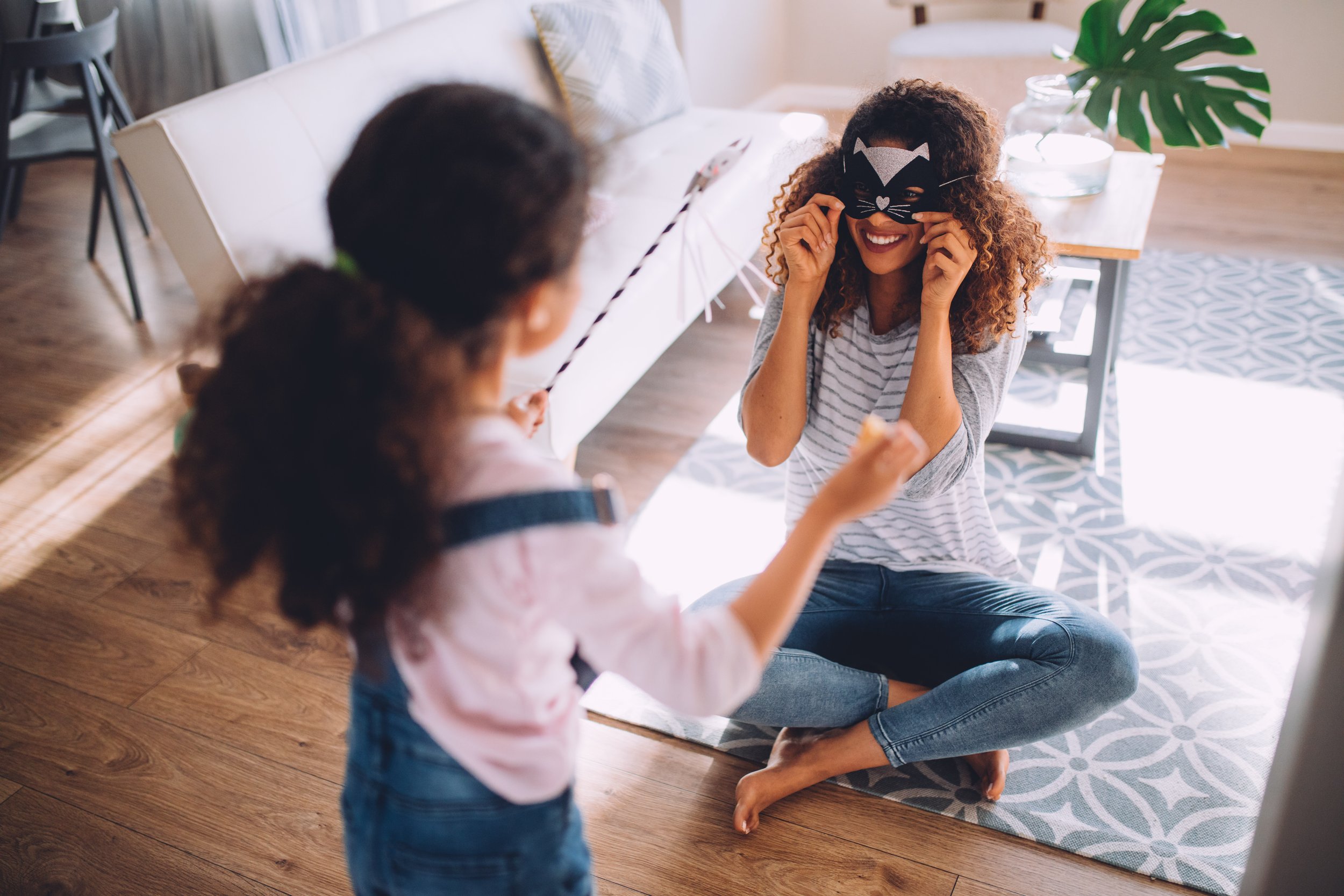 Playful Moments at Home: Mom and Daughter with Mask - Garden City Family Dentistry