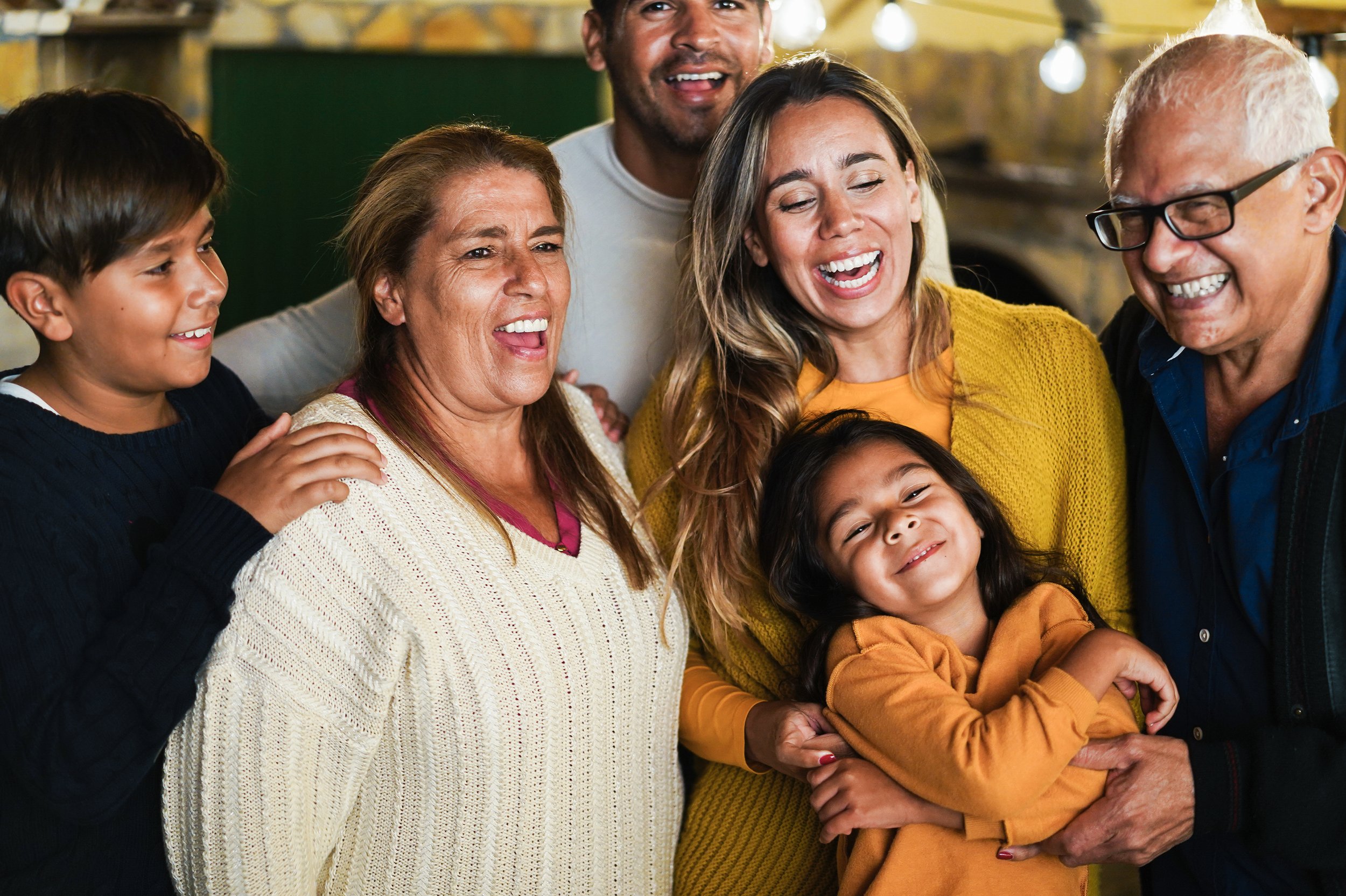 Joyful Gatherings: Ethnic Extended Family Smiling and Laughing - Garden City Family Dentistr