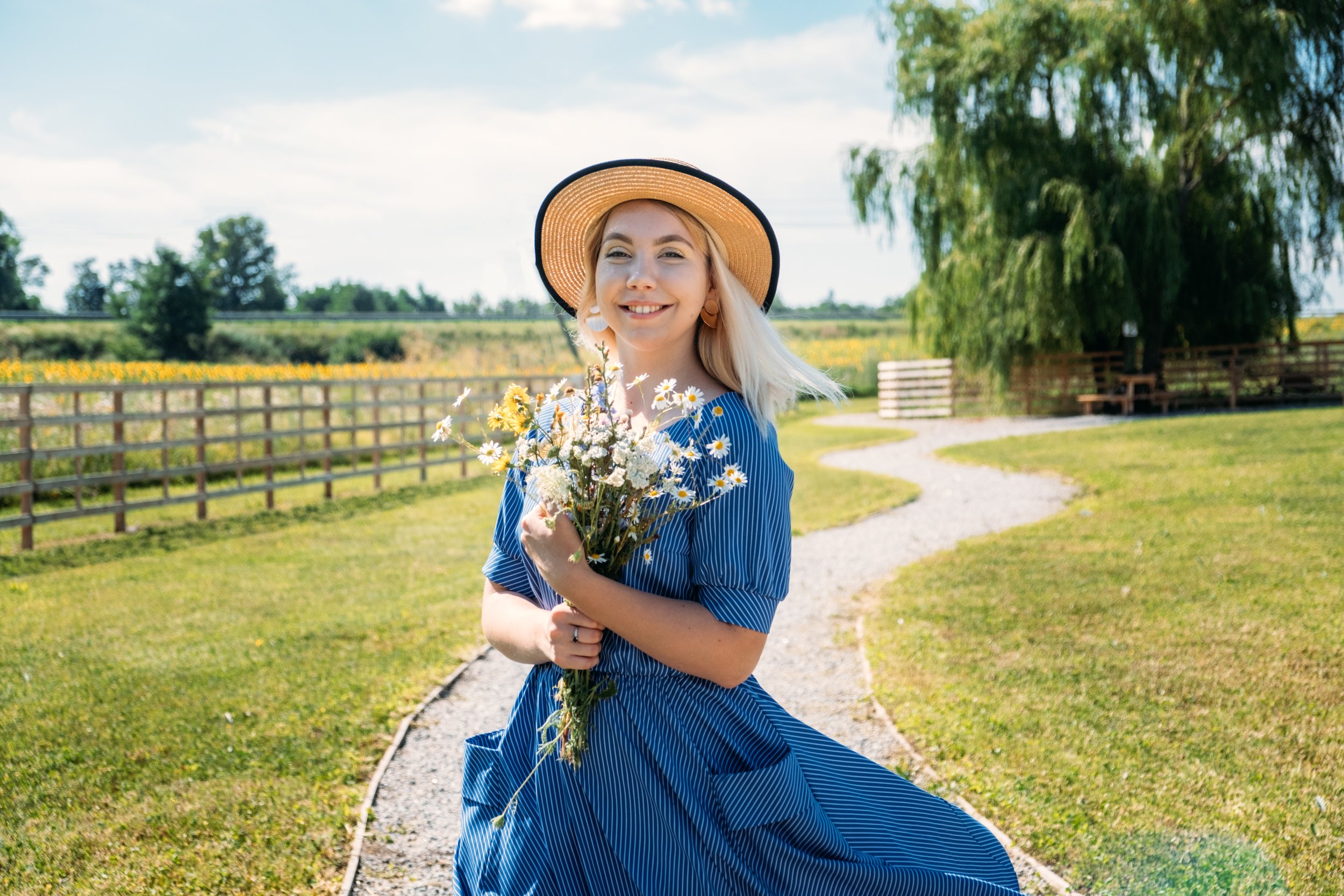 Countryside Serenity: Smiling Mennonite Woman with Flowers - Garden City Dental Health