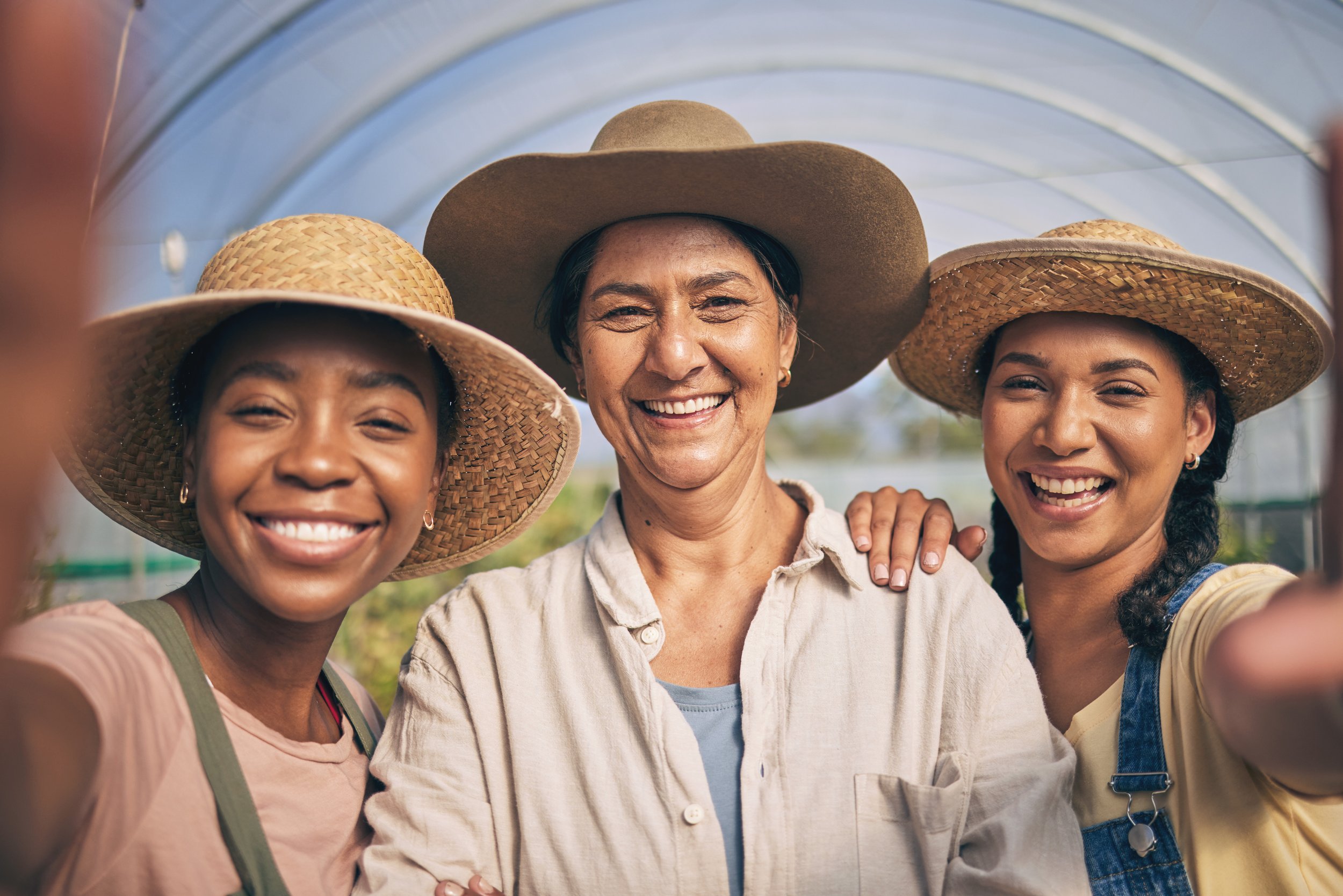 Diverse Joy: Three Ethnic Women Farmers Taking Selfie in Greenhouse - Garden City Dental Wellness