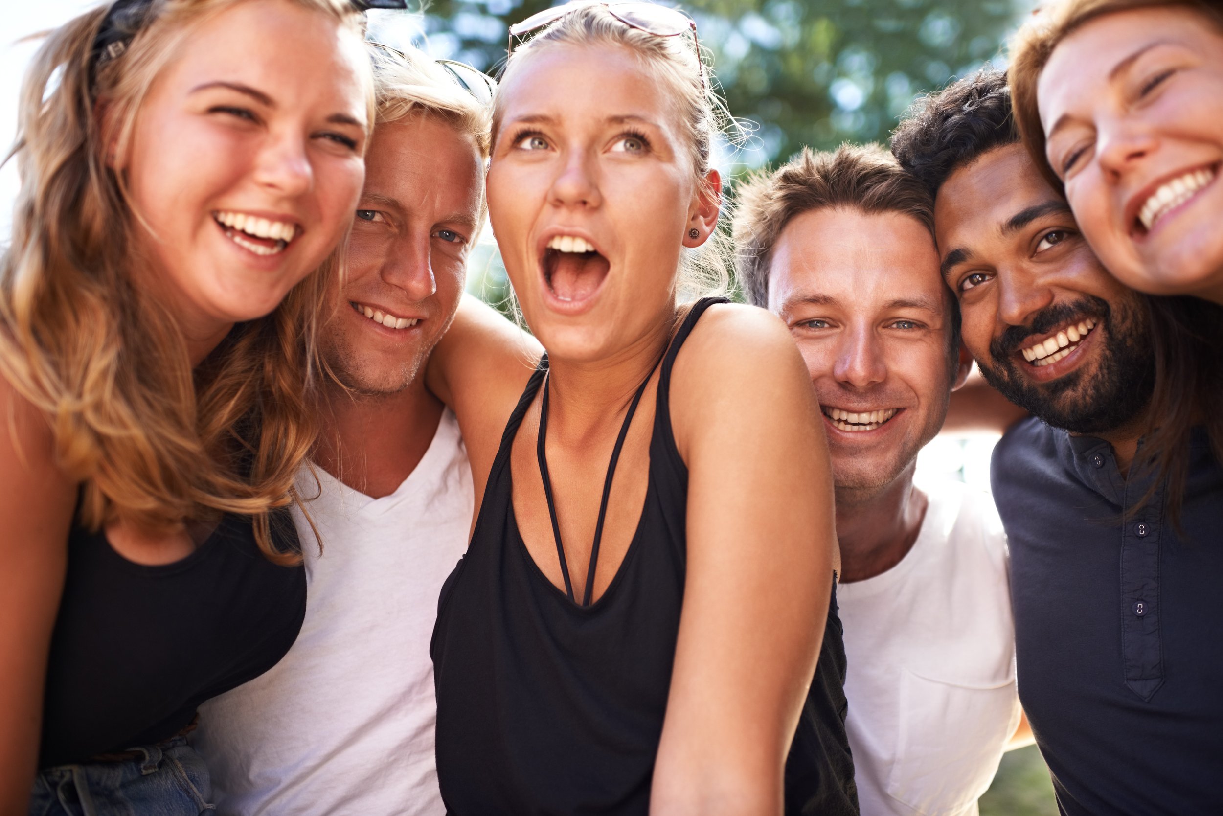Shared Laughter: Close-Up of Friends Laughing Together Outside - Garden City Dental Care