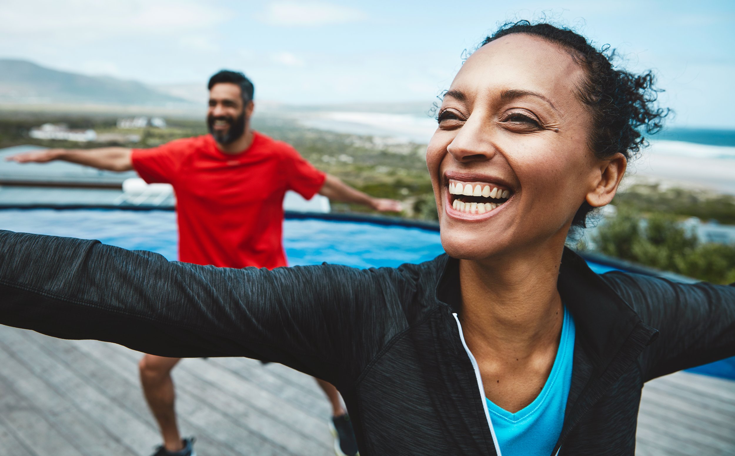 Harmony & Smiles: Couple's Outdoor Yoga on Beach Deck - Garden City Dental Wellness