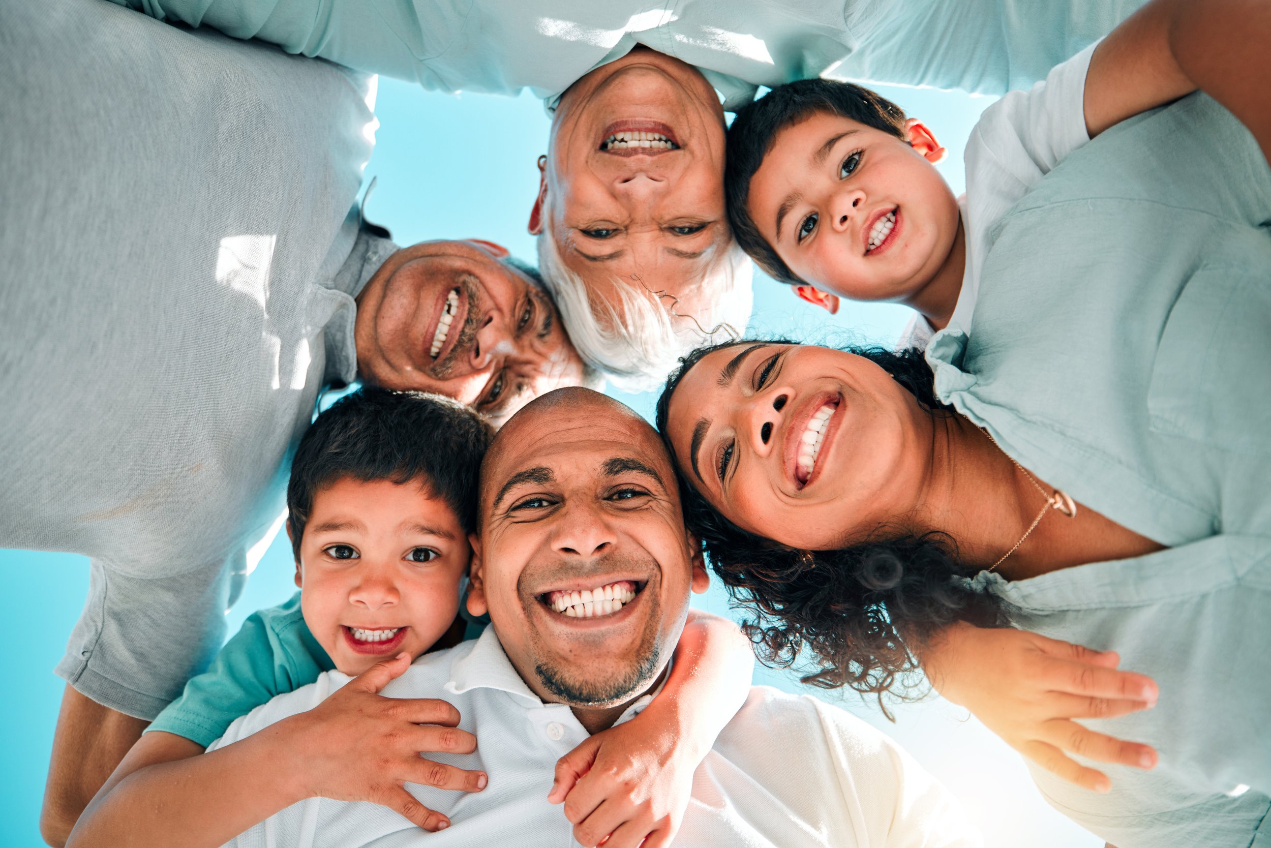 Skyward Smiles: Ethnic Family Looking Down - Garden City Family Dental Care