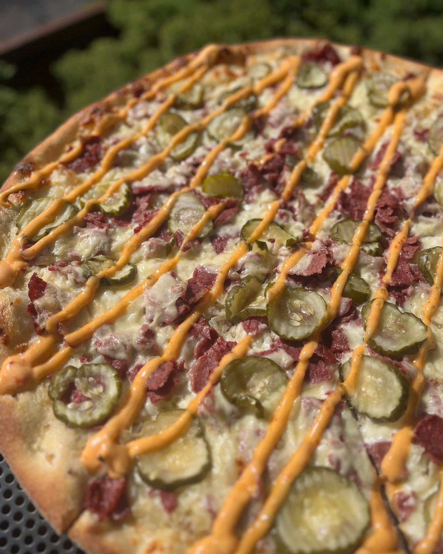The Rueben is back for the month of March! Sauerkraut base + mozzarella + corned beef + swiss + pickles + 1000 island drizzle.