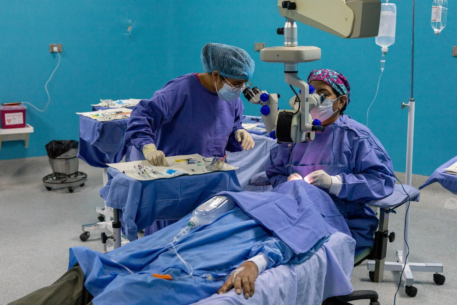 An eye-surgery team working with an operating microscope in Iquitos, Peru