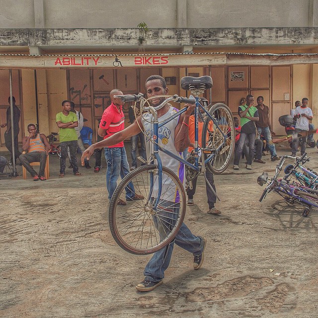 Here's our new friend Hashim Abibu at Ability Bikes about to rock a stylin' blue Schwinn here in Koforidua. Lots of folks have come out to see. K-dua has 130,000 people and seems like everyone's here. Man, we sure wish you were, because this is hands