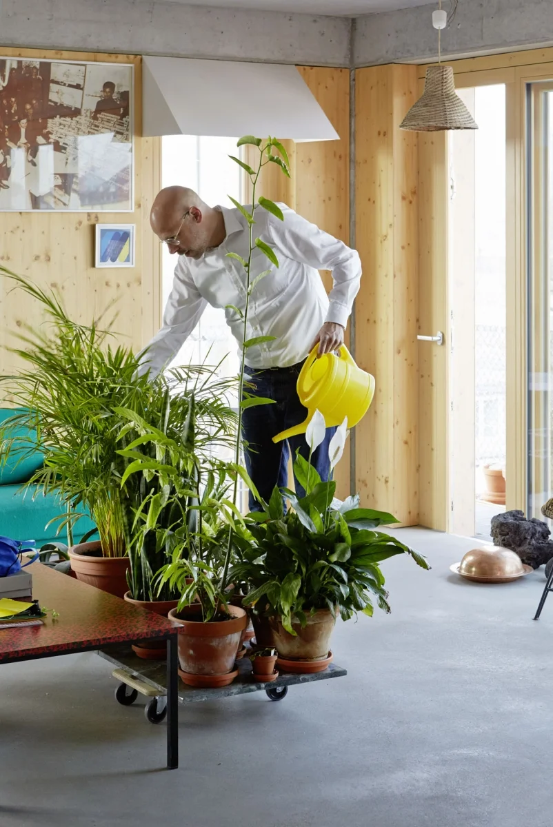 A resident waters a portable garden at the 50 Baugruppen in Berlin, a co-housing project designed to demonstrate how people can act as developers of their own homes.
