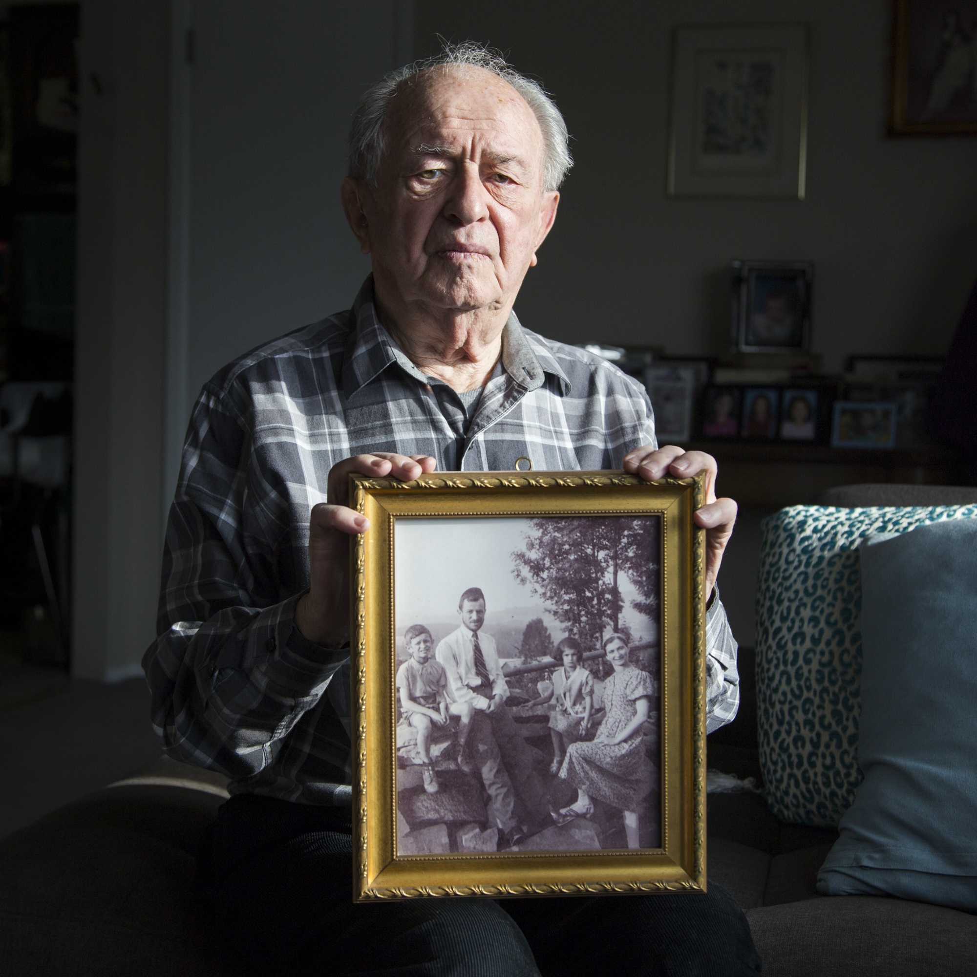 Holocaust survivor Arthur Spielman holds a photograph of his family just before the World War II broke out. The whole family survived, living with fake Roman Catholic papers in Hungary, but he lost all of his extended family in the Holocaust.