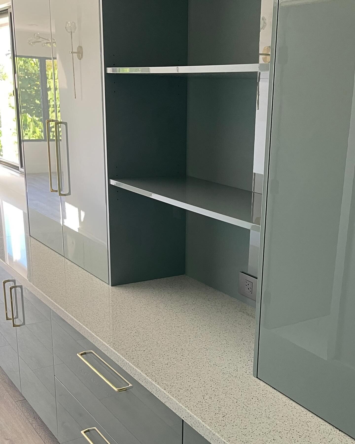 In a hallway leading to the bedroom, a craft station was designed in our high gloss Sage material.  A handy and beautiful space to house all the owner&rsquo;s craft papers, supplies and miscellaneous art.

Craft Cabinet:  Custom Sage high gloss, flat