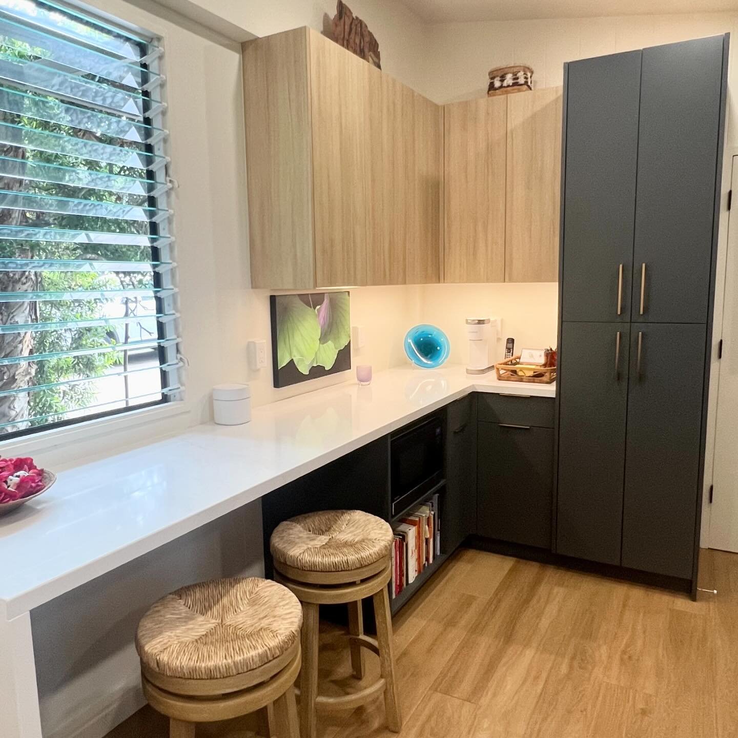 The eating nook of this kitchen includes a pantry for additional storage and a convenient microwave cubby.  The homeowners wanted a space to enjoy casual meals and morning coffee without taking up too much room in a small kitchen.  A cubby cabinet ke