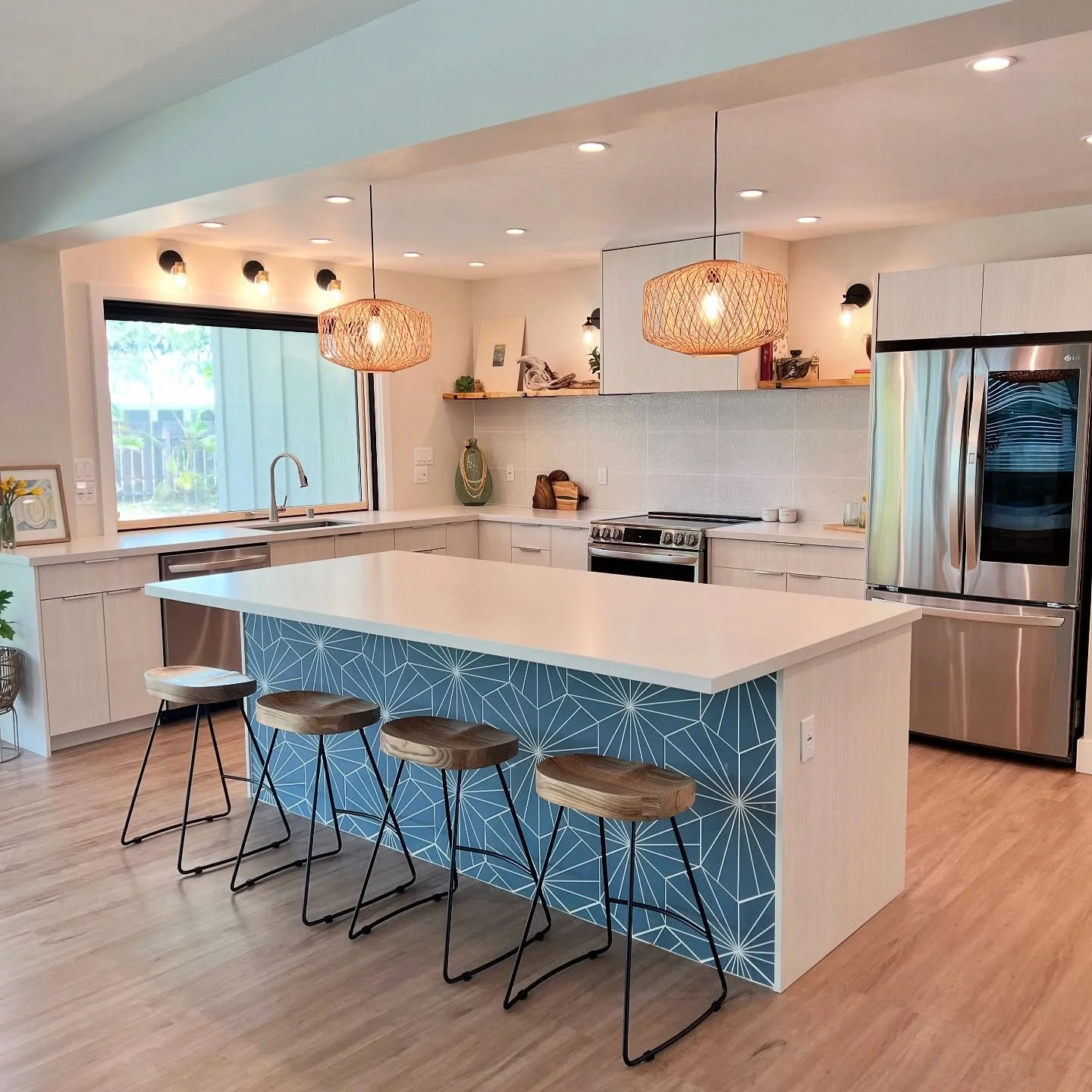 A white kitchen that&rsquo;s not boring.  Throwback to this Kailua kitchen from 2022.

&bull;a pop of color at the island breaks up the white cabinetry
&bull;floating shelving in a natural material adds interest and texture 
&bull;natural reed pendan