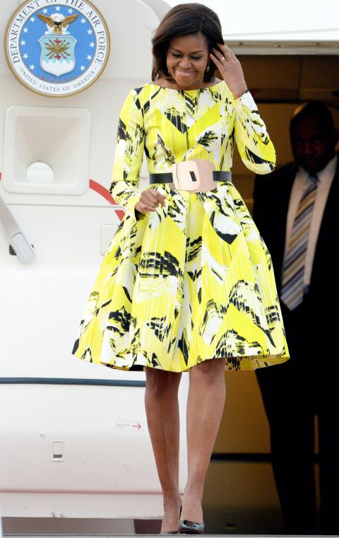 For her first visit to Japan, the First Lady arrived looking radiant in a lime green graphic-print dress by Kenzo. 