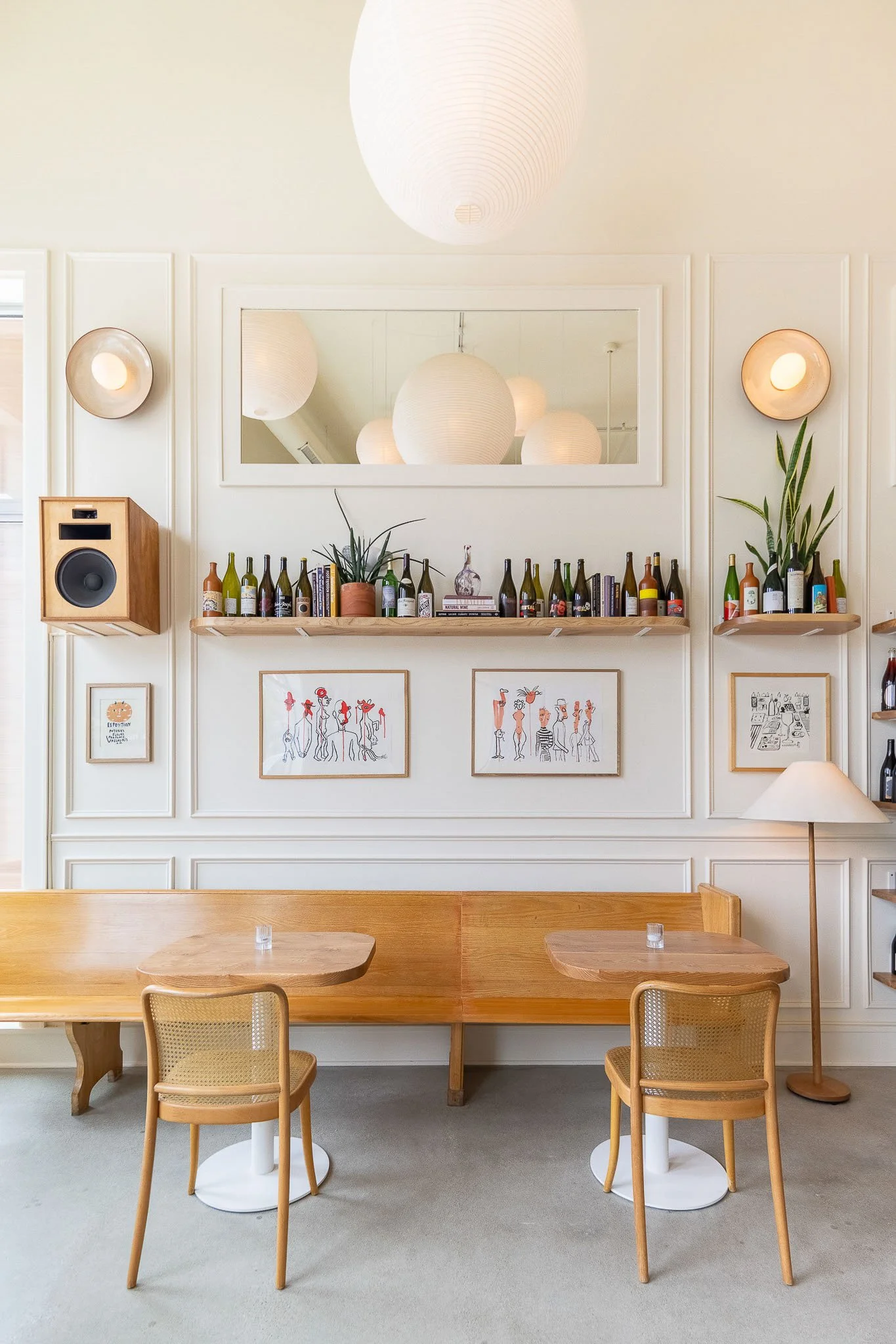 Expansive wine bar dining room with botanical floral wallpaper and warm ambient lighting — Milwaukee Non-Fiction wine bar commercial interior photography