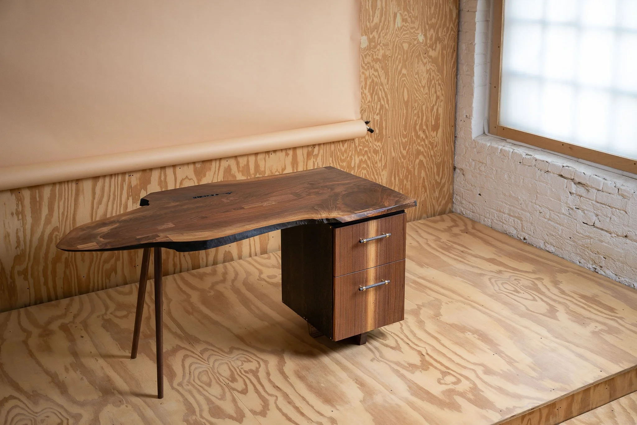 Custom live-edge walnut desk with warm wood grain and natural edge detail — Milwaukee product photography