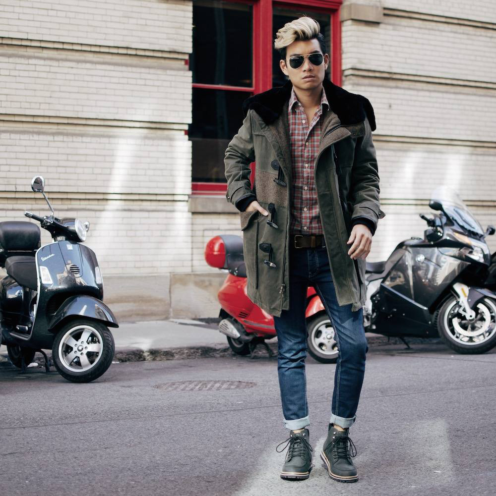 Alex wears the WILSON duffle coat in olive waxed cotton. It features a tough Riri CF zipper closure, a shearling lined hood, and a military blanket body lining. https://goo.gl/BwZ0oR