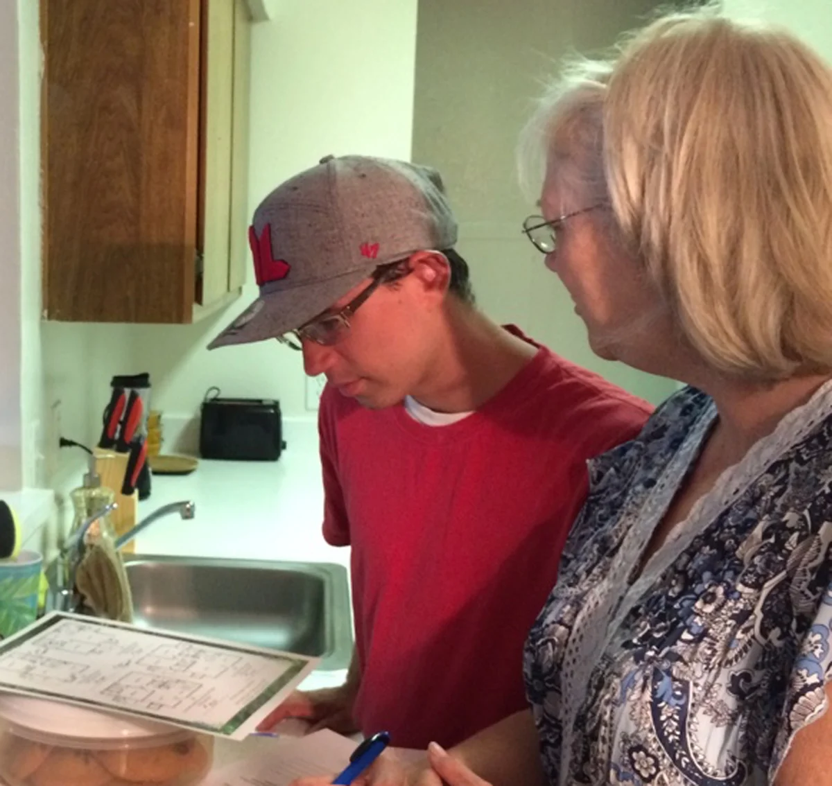 Son and Mom discussing apartment floor plans