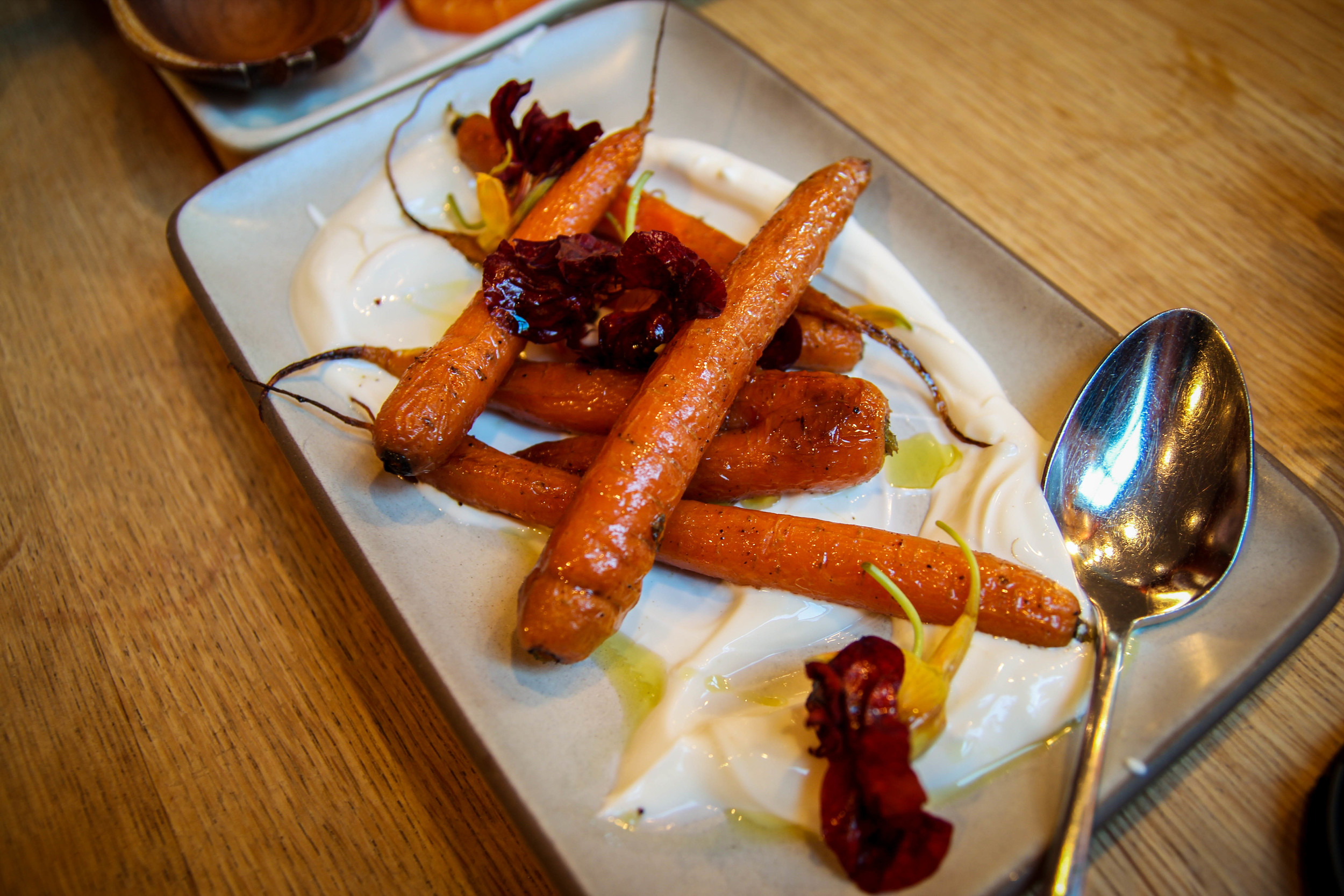Roasted carrots with Greek yogurt, lemon verbena, and nasturtium flowers