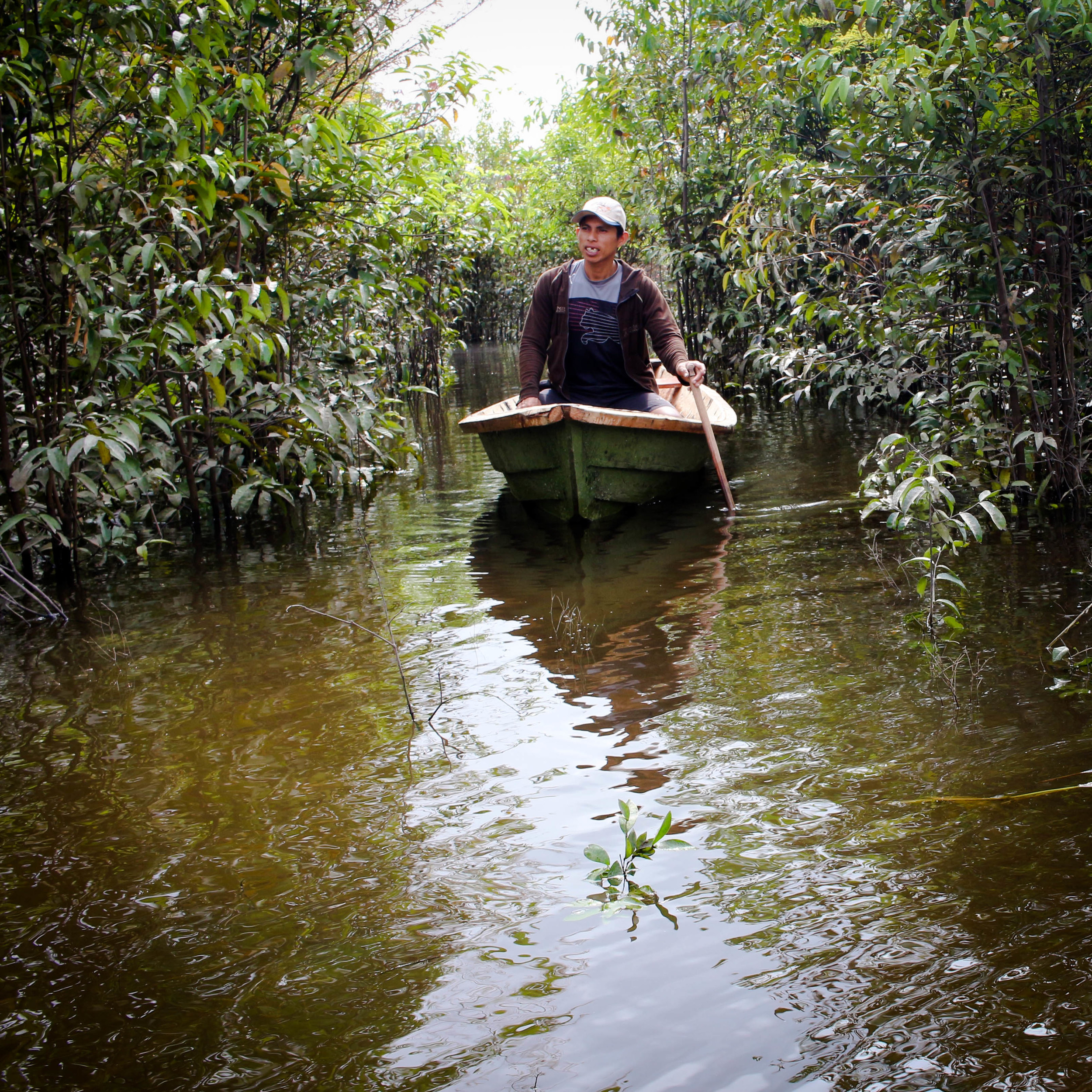 Hitching a ride from this local on the Amazon River after we reached Iquitos.