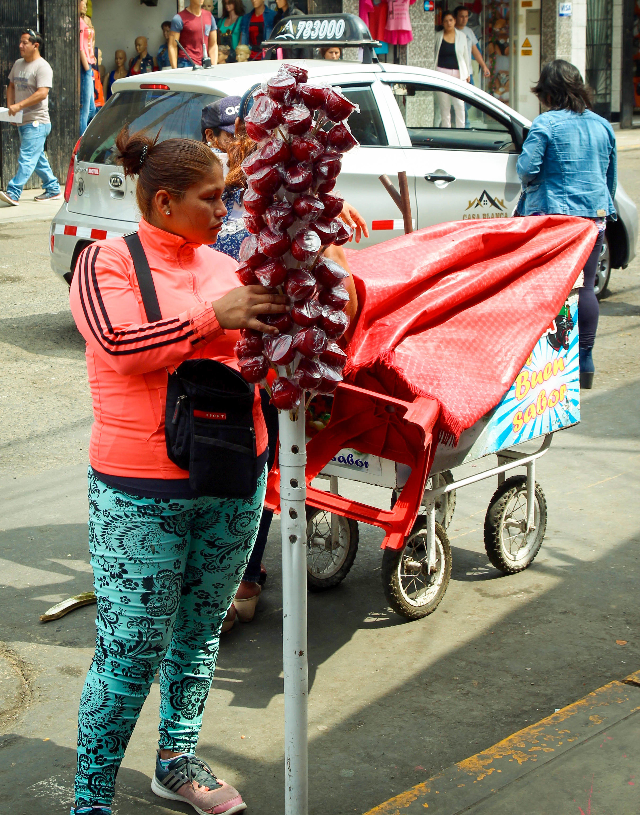 Sugar, sugar and more sugar. Amongst the scale vendors you will find many food vendors, most of whom sell sugary snacks (such as these red, candy apples) or mazamorra morada (Peruvian purple corn pudding). 