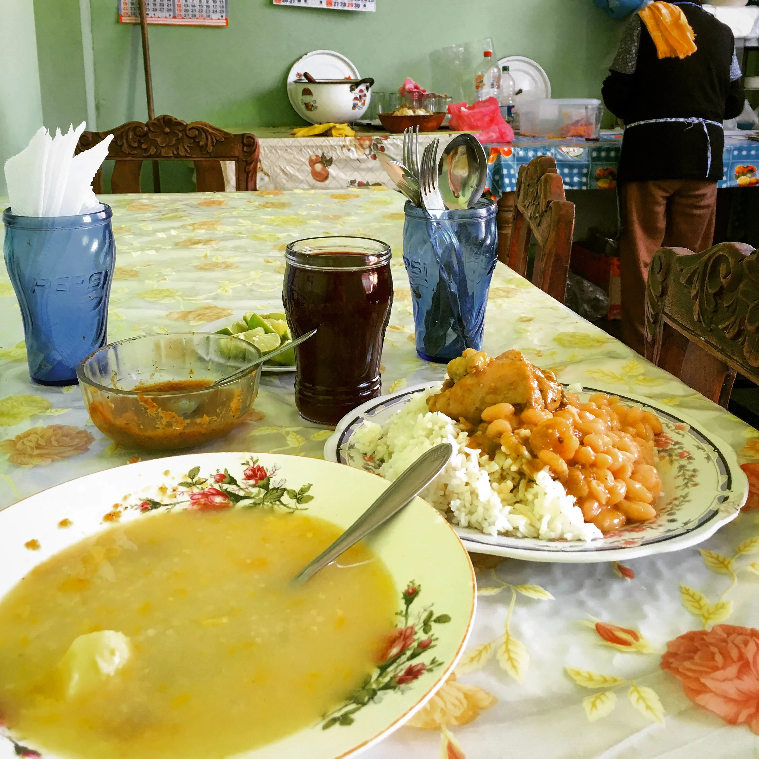 Eating my soup and stew in the kitchen. Esperanza always keeps out a bowl of lime slices and aji (Peruvian hot sauce).