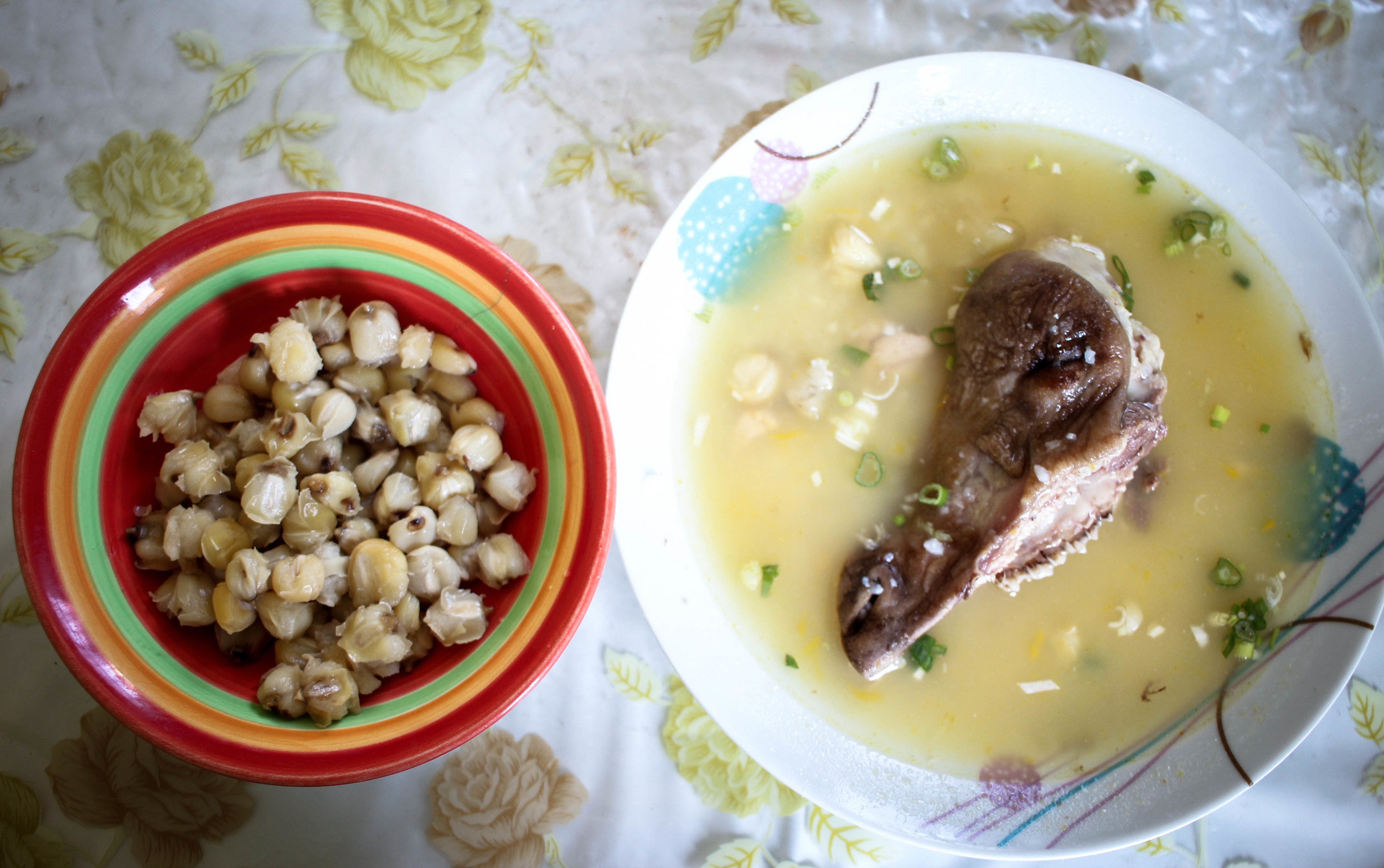 Mote (corn kernals) with caldo de cabeza (goat head soup).