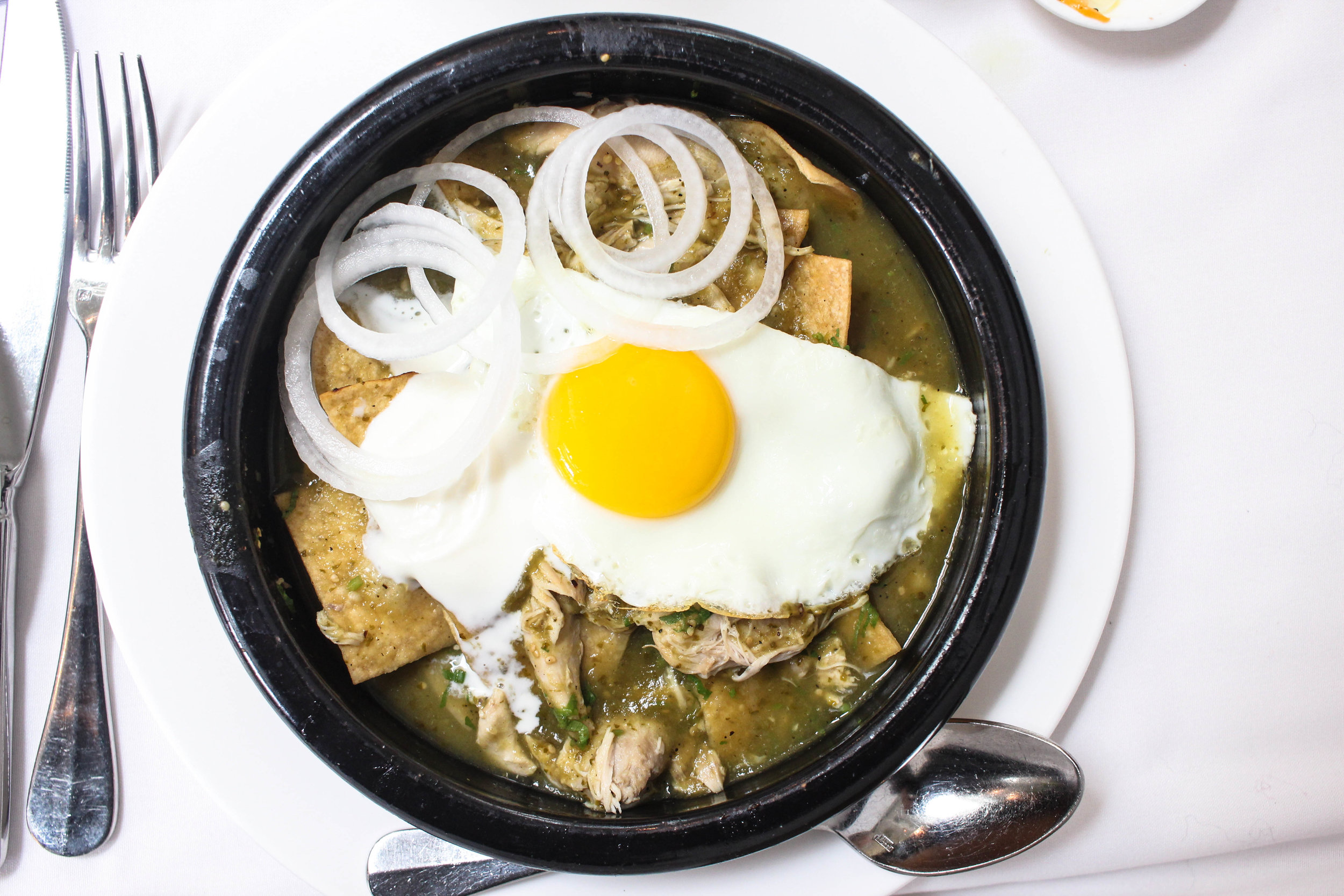 Chilaquiles verdes with chicken and a fried egg -view from above