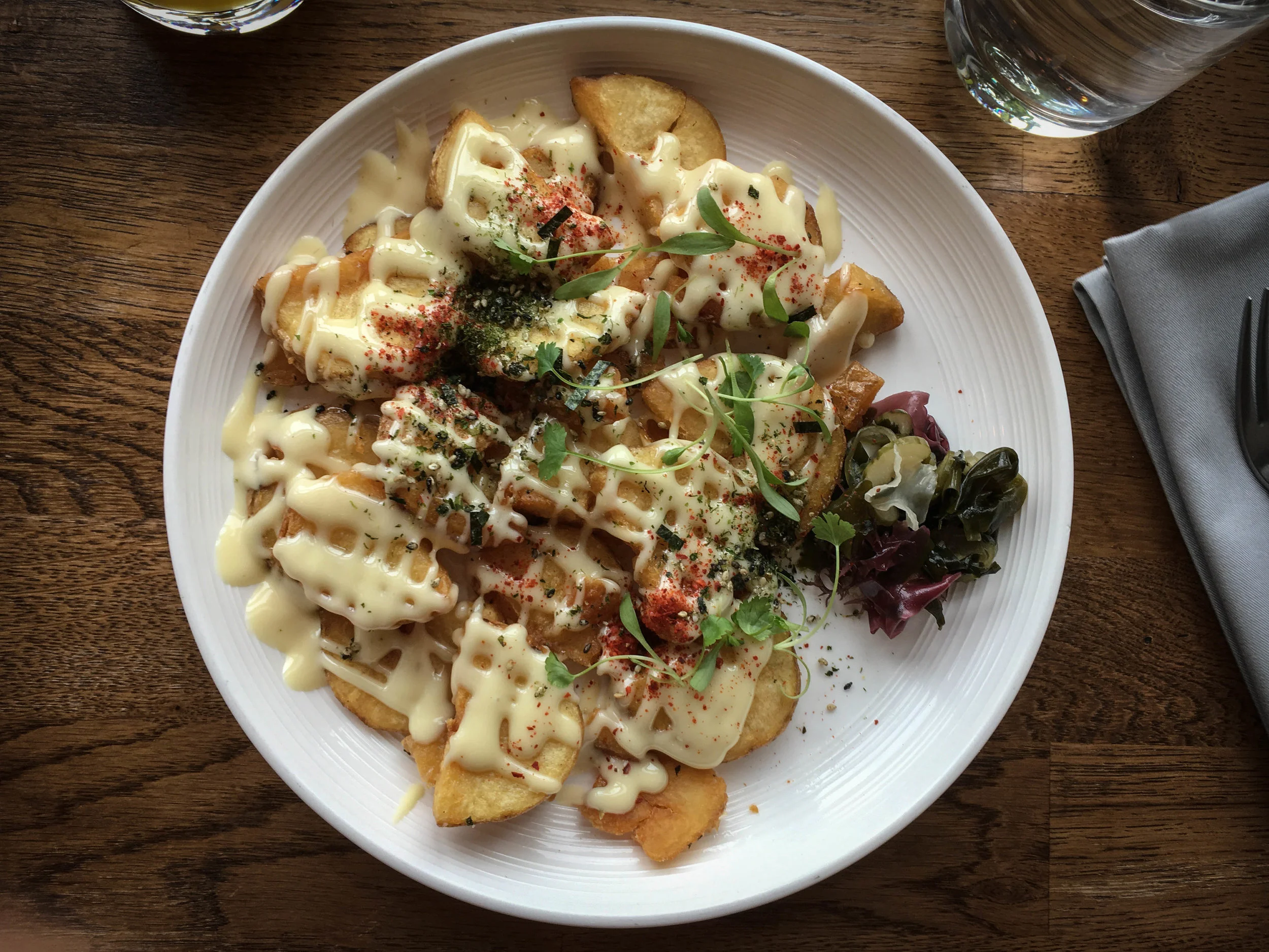 Breakfast Potatoes with kennebec potatoes, aïoli, furikake, compound butter, sunomono, micro mustard greens