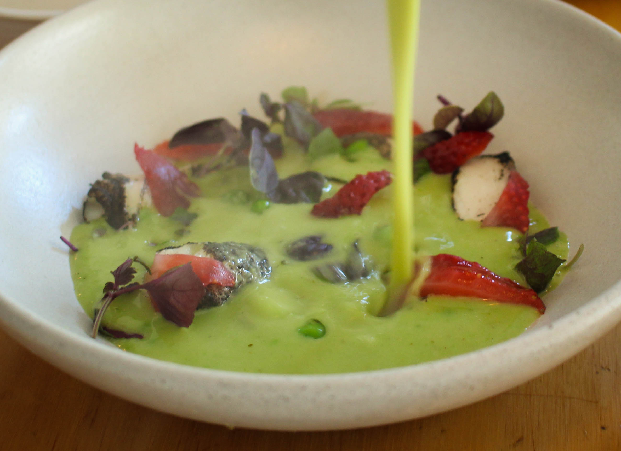 Green pea curry, black lime-cod, and pickled strawberries