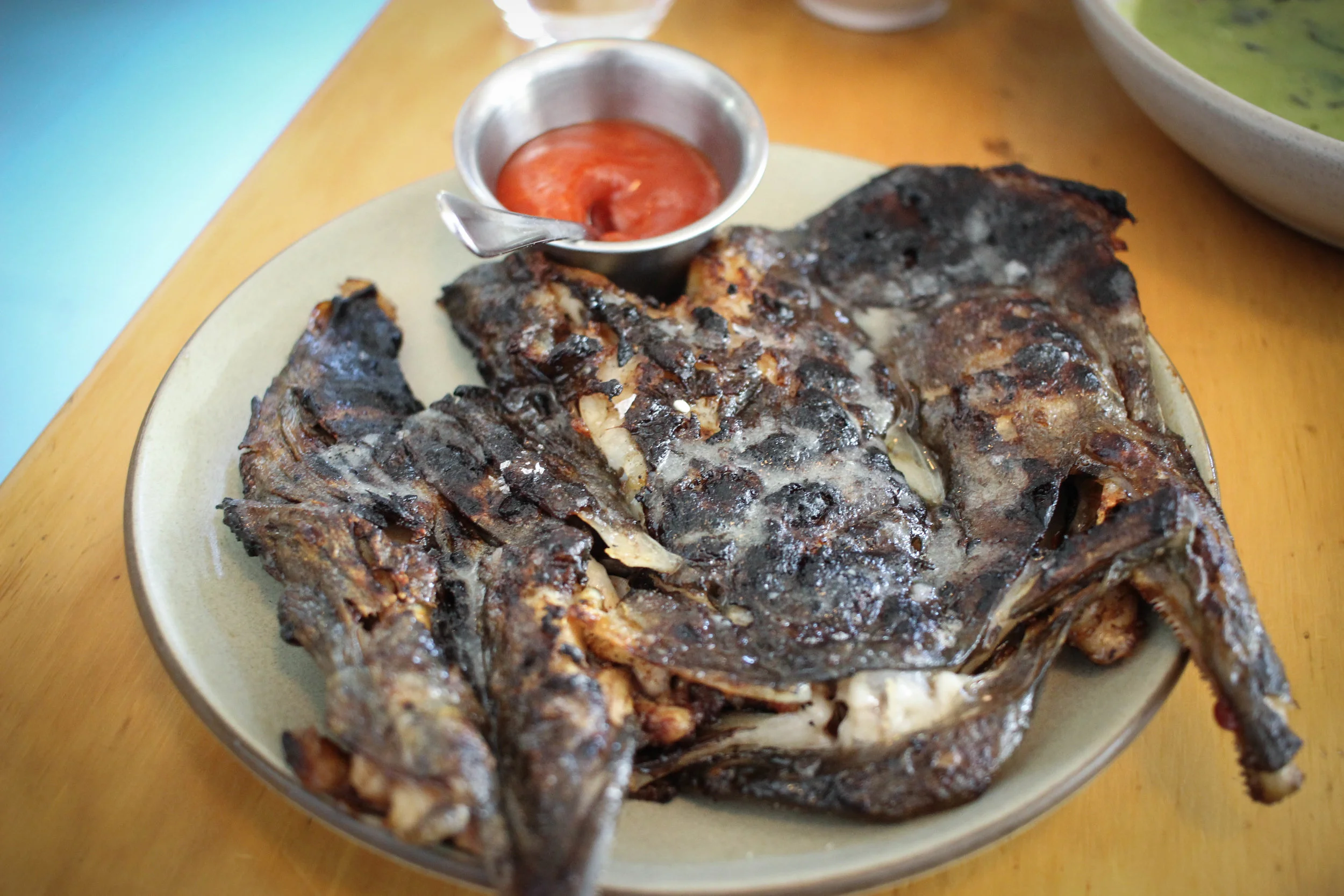 Fish head cooked under a brick with sweat and sour sauce