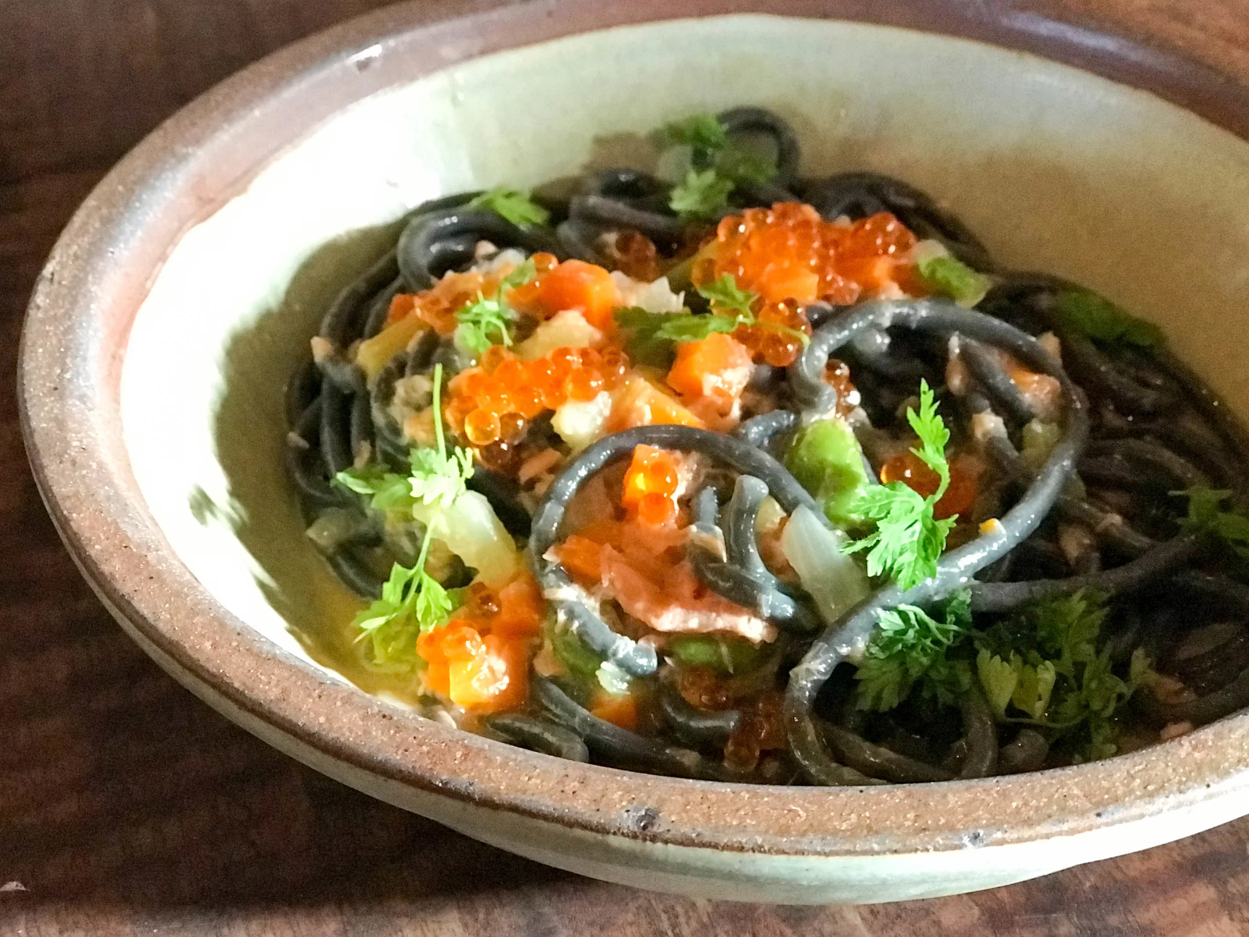 Squid ink bucatini with smoked salmon and fava beans