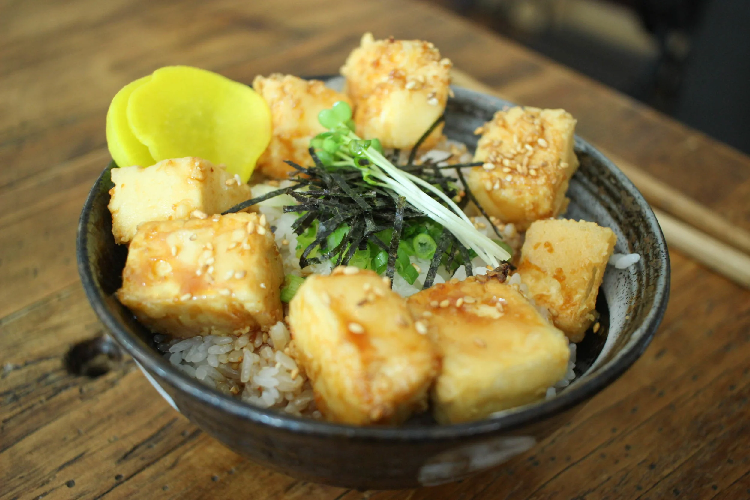 Tofu bowl with lightly deep-fried tofu served over rice.