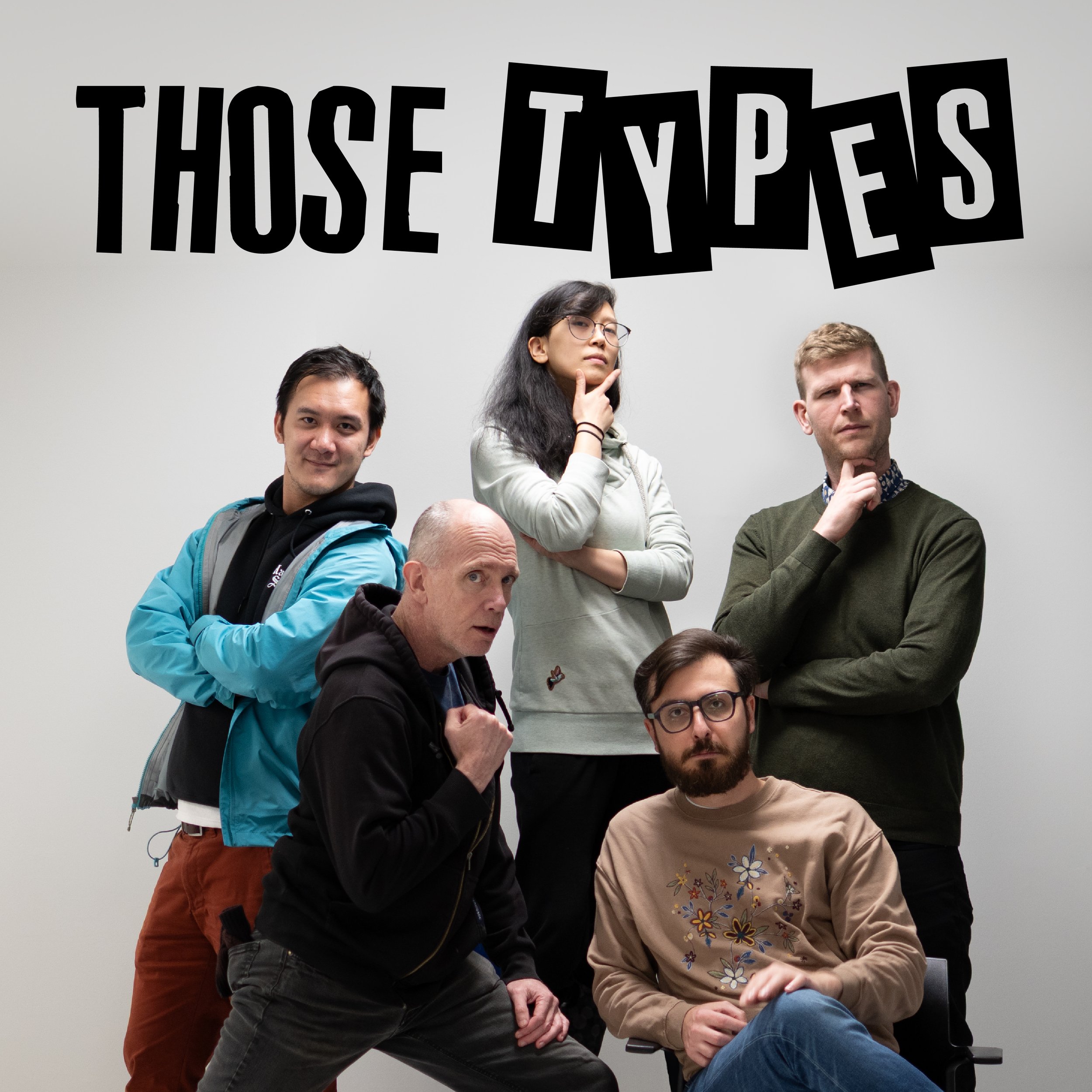A group of five improv comedians from Vancouver, Brandon, Duke, Rachel, Mark, and Rico, posing together in front of a blank white wall, with large black stylized text that reads 'THOSE TYPES' above their heads.