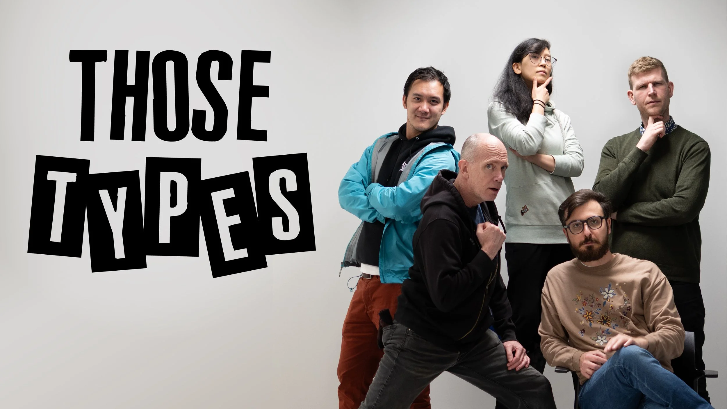 A group of five improv comedians from Vancouver, Brandon, Duke, Rachel, Mark, and Rico, posing together in front of a blank white wall, with large black stylized text that reads 'THOSE TYPES' above their heads.