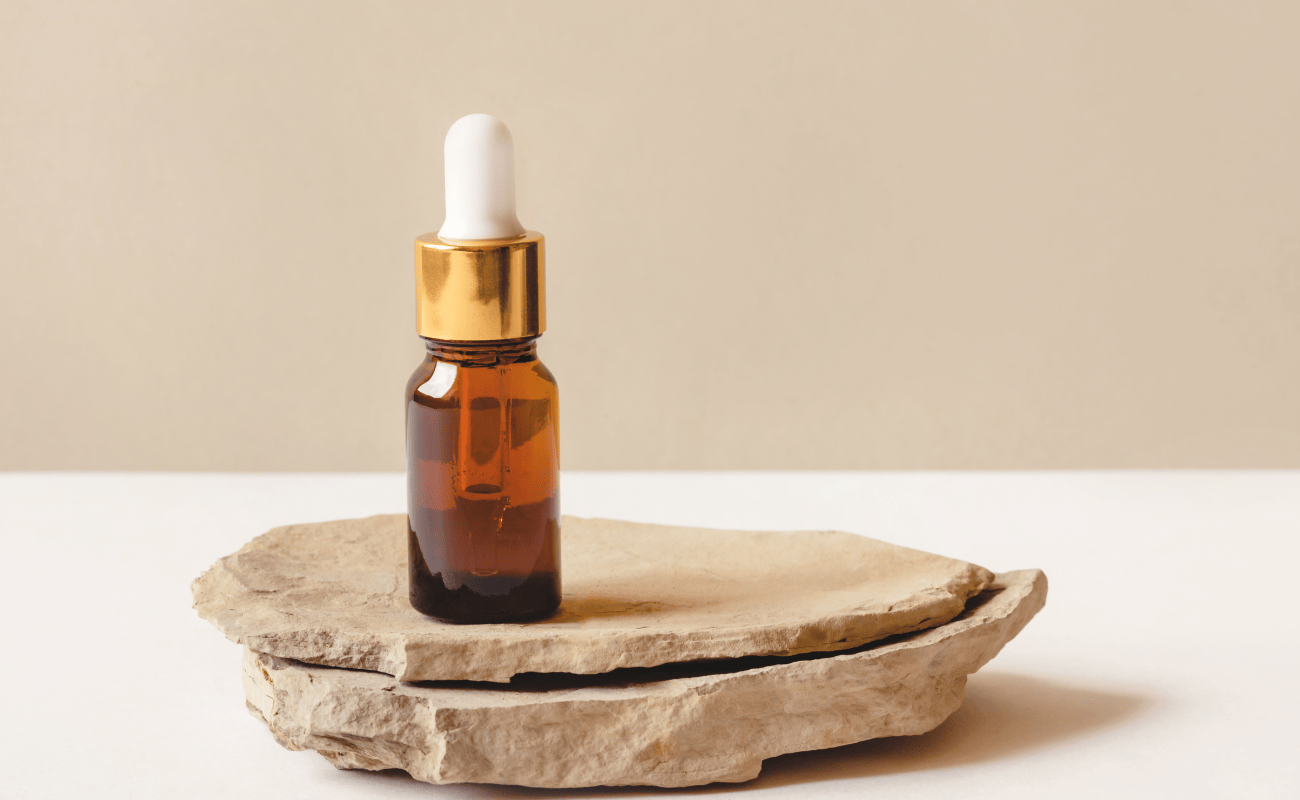 amber-spa-dropper-bottle-sitting-on-natural-stone