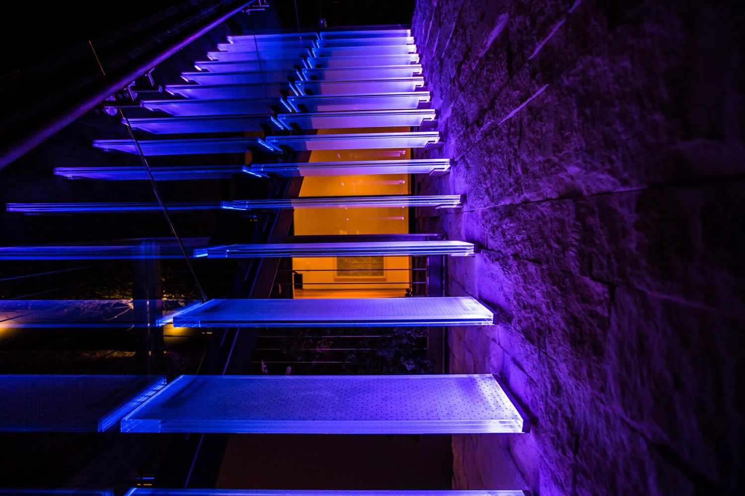 Acacia House modern interactive glass staircase installation. Programmable LED lighting provides a entertaining experience